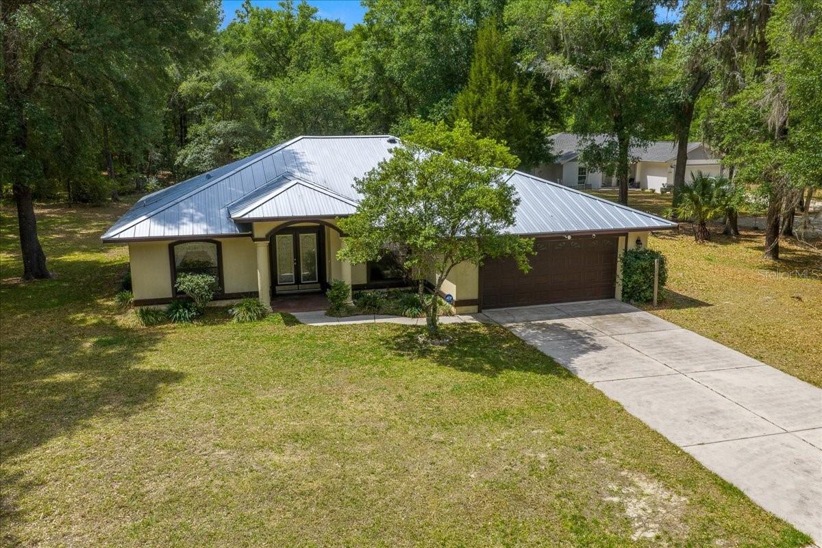 If you are looking for a home that prioritizes space, privacy, and a sensible layout, this 3-bedroom, 2-bathroom residence in a premier Citrus Springs location is a must-see. Situated on just shy of a half-acre, this property offers a level of quiet serenity that is becoming increasingly rare.

The interior features a highly functional floor plan with just under 2,000 total square feet, where every inch is designed for effortless daily living. From the main living area, a large slider opens to an expansive, oversized porch that looks out onto a backyard teeming with nature; it is common to see deer and turkey wandering through the landscape, creating a peaceful and personal sanctuary.

For added peace of mind, a brand-new full metal roof was installed in 2023, offering incredible durability and long-term protection. The home also features an energy recovery system that utilizes the AC condenser to help supply hot water, providing an added layer of energy efficiency and cost savings.

Complete with two detached sheds for ample storage or workshop space, this home perfectly balances utility with the beauty of a quiet country lifestyle.
