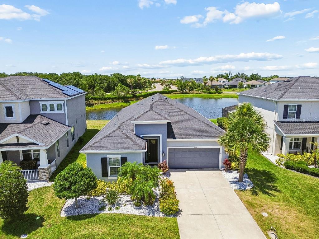 Welcome to your bright and airy 4-bedroom, 3-bathroom Antigua model home by Taylor Morrison in the highly desirable Artisan Lakes at Eaves Bend community. This executive lakefront home offers spectacular views of the lake with no backyard neighbors, providing ultimate privacy and plenty of room for a future pool.

Step inside a large and inviting grand entry hall leading to an open-concept great room, dining area, and kitchen filled with natural light and lake views. The chef-inspired kitchen is a standout, featuring a large island with quartz countertops, a generous walk-in pantry, a convenient butler’s pantry prep area, stainless steel appliances and hood, and a gas stovetop. The adjacent, large standalone, formal dining room is perfect for entertaining or can easily serve as an office, den, playroom, or homeschool area.

The spacious owner’s suite boasts a huge walk-in closet, dual-sink vanity, luxurious soaking tub, and a separate, oversized walk-in shower with built in bench. The large guest bedroom located at the front of the house offers its own private bathroom, while two additional bedrooms are located off their own private hallway and share a full bath. All four bedrooms feature newly installed wood plank laminate flooring for easy, low-maintenance Florida living. The main living areas showcase beautiful light-colored natural plank tile and fresh paint throughout.

Additional highlights include a fully-wired smart home, as well as brand-new Electrolux front-load washer and dryer with nearly 8’ high pantry cabinet in the laundry room for extra storage. 

Residents of Artisan Lakes at Eaves Bend enjoy a resort lifestyle with outstanding community amenities, including a stunning clubhouse, magnificent pool, large spa tub, state-of-the-art fitness center, full kitchen, meeting hall, co-working center, billiards big screen TV room, library, dog park, playgrounds, basketball courts, and soccer fields. This prime location offers convenient commuting north or south, making it easy to embrace the Sunshine State lifestyle.

Don’t miss this opportunity to own your coastal retreat in this luxurious home. Schedule your private showing today!