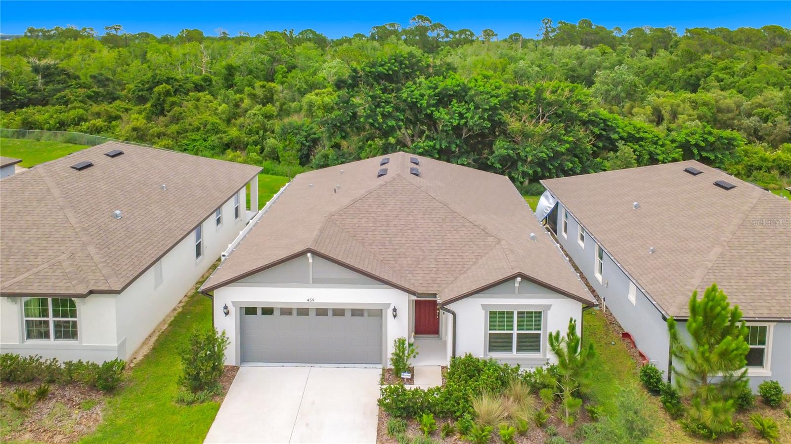 SPECTACULAR NEW HOME WITH BEAUTIFUL VIEW OF TREES OUT BACK! NO REAR NEIGHBORS! This home was built at the end of 2024. It has been cared for, but sellers need to move and pass this beautiful home onto the next owner. They have FULLY FENCED the YARD in for COMPLETE PRIVACY and SCREENED the COVERED LANAI! They also had a They also had a 240 VOLT WALL PORT FOR ELECTRIC CAR CHARGER INSTALLED IN GARAGE. Garage floor has epoxy. This home is LESS THAN TWO YEARS OLD and has been maintained in pristine condition! Once entering the home, you will find a large foyer that leads to a very open great room, kitchen and dining area, all looking out over the beautiful and PRIVATE TREELINED BACKYARD. The Master Bedroom is at the back of the home, overlooking the beautiful view and has a large walk-in shower in the bathroom and a large walk-in closet! The home is located in a QUIET, SMALL COMMUNITY OF UNDER 80 HOMES tucked away in a quiet loop. It is located just a few minutes from I-4 putting this home with easy access to anywhere you want to go. Just a HALF HOUR to DISNEY, LESS THAN A HALF HOUR to LAKELAND. This is in a great area with PUBLIX and MANY SHOPS COMING SOON that will be just steps away for the ultimate convenience. This location offers easy access to all major roadways for easy commutes to restaurants, shoppes and anywhere you want to go! COME LIVE IN THE HEART OF IT ALL YET, TUCKED AWAY IN A PEACEFUL QUIET ENCLAVE where you can sit in your backyard and hear nothing but the quiet sounds of birds chirping and wind rustling through the trees. Come visit this amazing, warm and friendly neighborhood because you are sure to want to stay forever!