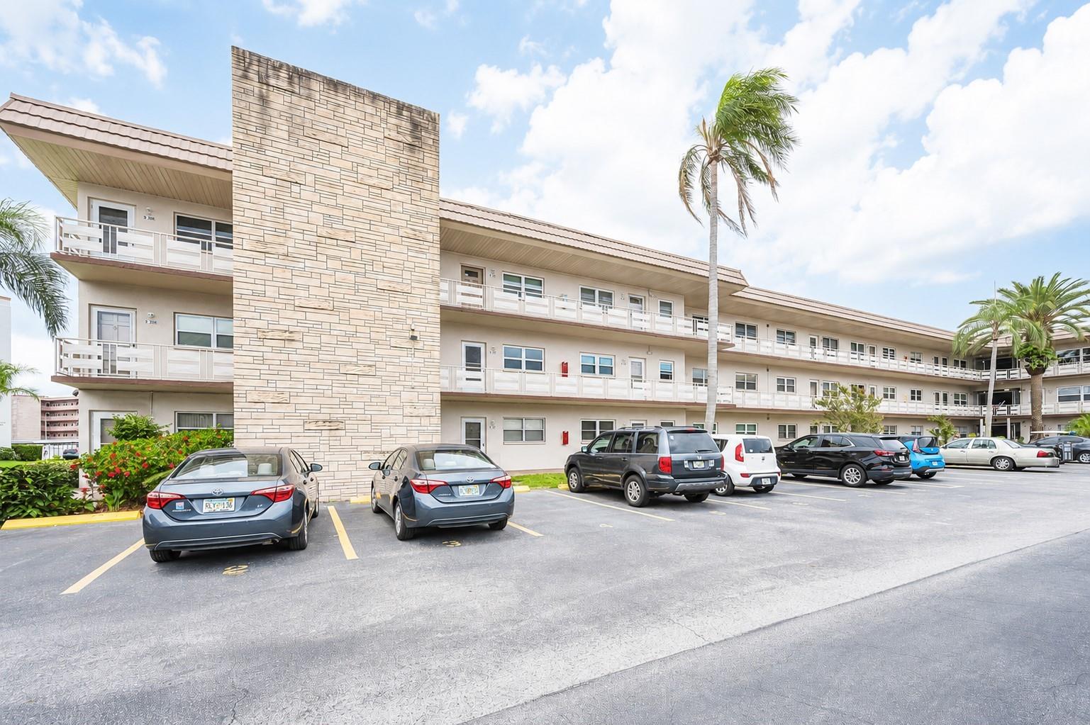 One or more photo(s) has been virtually staged. Welcome home to this beautifully updated 2-bedroom, 2-bath CORNER condo in the desirable Amherst Building at Five Towns, one of St. Petersburg's most sought-after active communities. Located on the third floor, this light and bright end unit offers added privacy along with peaceful garden views highlighted by a stunning magnolia tree right outside your windows. Updates include hurricane-impact windows, new appliances, fresh interior paint, and stylish new flooring throughout, making this home truly move-in ready. The spacious floor plan provides comfortable living and entertaining space, while the covered carport adds everyday convenience. Five Towns is known for its exceptional resort-style amenities, including multiple heated pools, scenic ponds, two large clubhouses, fitness center, library, billiards room, shuffleboard courts, tennis courts, and a full calendar of social activities and events. Ideally located near shopping, dining, medical facilities, entertainment, downtown St. Petersburg, and the Gulf beaches, this condo offers the perfect combination of comfort, convenience, and active Florida living. Don't miss your opportunity to own a beautifully updated corner unit in one of St. Petersburg's premier 55+ communities.