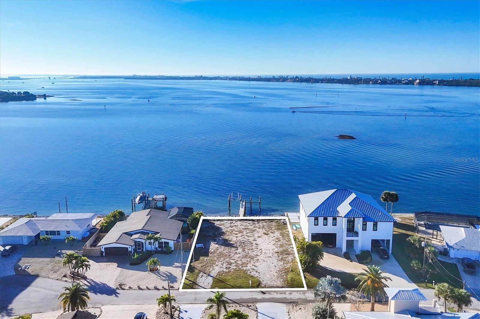 This is a truly exceptional opportunity to own what may be the finest waterfront lot available in Englewood, Florida. Perfectly positioned with sweeping, unobstructed views of Lemon Bay and the Intracoastal Waterway, this stunning property offers the ideal setting to design and build your custom dream home. The seller had plans to build but decided otherwise—now the vision can be yours.
Enjoy the best of both worlds with serene waterfront living and the energy of a charming coastal town just moments away. Located just around the corner from downtown Englewood and Historic Dearborn Street, you’ll be within easy reach of inviting coffee shops, popular restaurants featuring live jazz, a weekly Farmer’s Market, monthly car shows, festive holiday celebrations, boat parades, and so much more.
Whether you’re envisioning peaceful mornings watching the boats glide by or evenings immersed in Englewood’s lively local culture, this prime location delivers it all. Don’t miss this rare chance to own a premier piece of paradise and bring your dream home to life on the water.