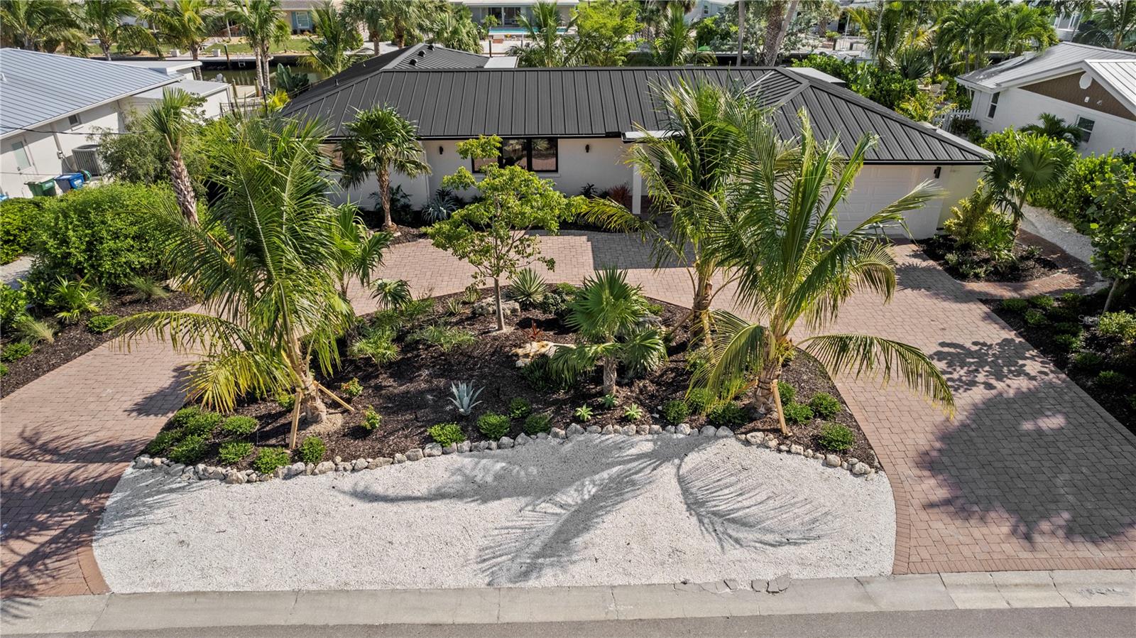 Welcome to Southern Exposure!  One of the best things about coming to sunny Florida from the cold North is a home with Southern Exposure so you can bask in the sun by this amazing pool all day long!  Tranquil, private waterfront sanctuary — 624 Dundee on Key Royale is an impeccably renovated residence offering modern-luxe living by the water. This refined 3-bedroom, 2-bath pool home blends effortless flow with elevated finishes throughout. Meticulous landscaping and elegant paved walkways welcome you, while thoughtful attention to detail is evident in every room. Outdoors, a perfectly scaled heated pool and generous sun terraces are complemented by covered lounge space for sophisticated alfresco living and dining. A fully equipped dock with a 10,000 lb lift invites effortless access to open water, fishing, kayaking, or paddleboarding amid abundant coastal wildlife. Entertain beautifully: a sleek, brand-new kitchen with island opens to the dining area and elongated living room, creating seamless indoor-outdoor flow. The primary suite sits poolside with a private ensuite—ideal for morning swims or coffee on the lanai with sunshine all day!  Two additional bedrooms share a well-appointed bath and can easily convert to a chic home office or guest quarters. Perfectly positioned on the island, this home captures the quintessential Anna Maria lifestyle—relaxation, sunlit days, and waterfront adventures—ready to be enjoyed as an exquisite primary residence or a sophisticated addition to your investment portfolio.