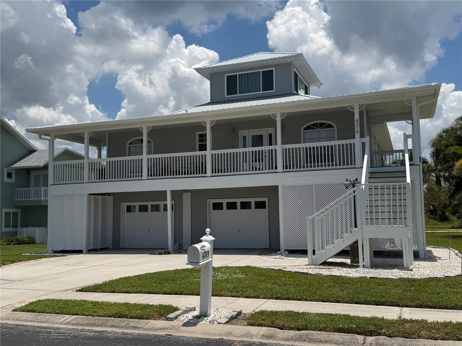 Welcome to the highly sought-after Heritage Bay community on beautiful Snead Island, where coastal charm, privacy, and the timeless appeal of Old Florida create an exceptional place to call home. This elevated Key West-style residence offers 3 bedrooms, 2 bathrooms, and an oversized garage with room for 4+ vehicles, boats, golf carts, and recreational toys, plus a dedicated workshop.

The spacious galley kitchen features granite countertops, solid ivory wood cabinetry, decorative tile backsplash, Samsung stainless steel appliances, Kenmore Washer and Dryer and a convenient butler's pantry. The open living area is filled with natural light and flows seamlessly to expansive covered porches with preserve views and glimpses of Terra Ceia Bay. The home features beautiful 20" x 20" decorative ceramic tile throughout the main living areas, while all bedrooms are comfortably carpeted.

The private primary suite offers a spacious walk-in closet and an impressive en-suite bath with dual vanities, large soaking tub, huge tiled walk-in shower, private water closet, and direct access to the rear balcony. Upstairs, the versatile third-floor loft with impact windows and a private balcony can serve as a guest suite, home office, media room, or playroom.

Outdoor living is one of this home's greatest features. Enjoy the welcoming front porch, spacious rear porch overlooking the preserve, or head to the rooftop sun deck for panoramic bay views.

Recent improvements include a new metal roof, new electrical panel, impact-rated front entry door, and impact windows in the third-floor loft.

Heritage Bay residents enjoy access to a community pool and tennis courts just a short stroll from the home.

Living on Snead Island is about much more than owning a home—it's embracing a lifestyle. Home to approximately 300 residences, the island offers a peaceful atmosphere with only a handful of commercial businesses, including the Bradenton Yacht Club, marina, and local nursery. With no traffic lights, minimal traffic, and one road in and out, residents enjoy a relaxed pace of life that is becoming increasingly rare.

Just minutes away is Emerson Point Preserve, a stunning 500-acre State Park where Tampa Bay, Terra Ceia Bay, and the Manatee River meet. Enjoy miles of walking and biking trails, kayak launches, an observation tower, abundant wildlife, a dog-friendly beach, picnic areas, and spectacular sunsets year-round.

The island's welcoming community is one of its greatest treasures. Neighbors travel by golf cart, ride horses, walk dogs, and gather together throughout the year. A beloved holiday tradition lights the island's streets with candlelit sandbags each December, creating a magical setting and strong sense of community that makes Snead Island so special.