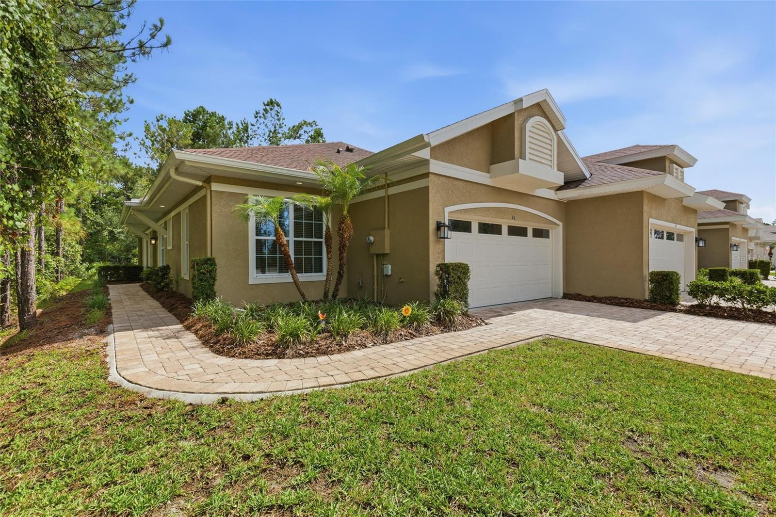 Welcome to 46 Heron Wing, where carefree living meets comfort, style, and peace of mind. Built in 2018, this concrete block 3-bedroom, 2-bath villa with a 2-car garage is ideally situated on a quiet cul-de-sac and offers the privacy of an end unit with a tranquil, serene backdrop enjoyed from both the living areas and screened lanai. Inside, you'll find soaring ceilings, tile flooring, an updated color palette, ceiling fans, window treatments, granite countertops, stainless steel appliances, and an included washer and dryer. The thoughtfully designed split-bedroom floor plan provides privacy for owners and guests alike, while the spacious dining area and extended counter-height breakfast bar create the perfect setting for entertaining family and friends. Extensive storage, meticulous maintenance, and a truly turnkey condition make this home move-in ready from day one. Additional touches such as recessed lighting along the extended soffits add warmth and character throughout the living spaces. At Huntington Village, the appeal goes beyond the home itself. This is the lifestyle you've worked hard to enjoy. Lock the door and travel with confidence. Spend less time maintaining a property and more time doing the things you love. Whether you're escaping winter, downsizing, or simply embracing a more carefree chapter, 46 Heron Wing offers the opportunity to come and go at your leisure while enjoying the comfort of a beautifully maintained home. Close to I-95, medical facilities, shopping, dining, and entertainment, you'll spend less time driving and more time enjoying life. And if you're ever unsure which direction to go, simply head east. You'll eventually arrive at the Atlantic Ocean. We recommend stopping before you reach the surf line. You've worked hard for this chapter of life. Now it's time to enjoy it. Welcome home to 46 Heron Wing. All information and measurements are intended to be accurate but are not guaranteed and should be independently verified.