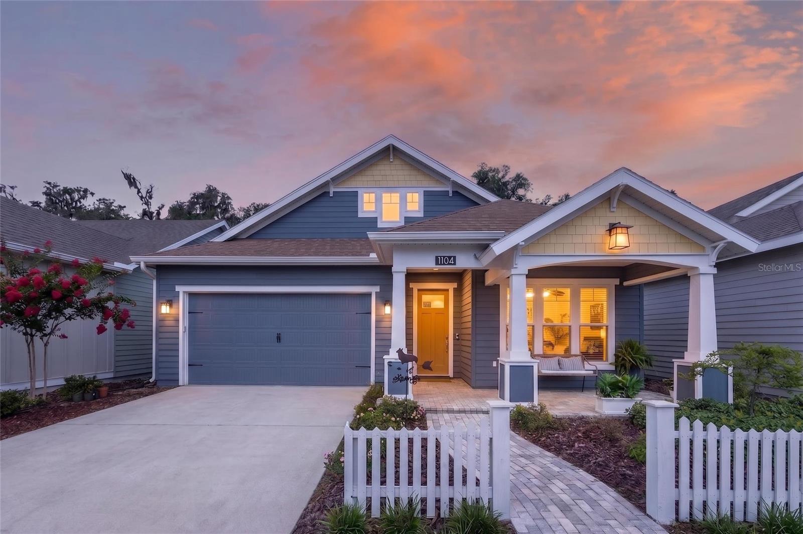 Welcome to this beautifully maintained 3-bedroom, 2-bath home with a dedicated flex space/office and a two-car garage, offering the perfect blend of style, functionality, and low-maintenance living. Designed with an open and inviting layout, the home features 10-foot ceilings, 8-foot doors, and luxury vinyl plank flooring throughout the main living areas. The spacious kitchen is both elegant and practical, showcasing granite countertops, a large undermount sink, solid wood cabinetry with soft-close drawers and doors, stainless steel appliances, a built-in oven and microwave, gas cooktop with vented hood, and abundant recessed lighting. The living room is filled with natural light and features a tray ceiling and glass doors leading to the covered and screened lanai, creating a seamless indoor-outdoor living experience. Whether enjoying a quiet morning coffee or entertaining guests, this space is designed for everyday comfort. The private primary suite offers a generous walk-in closet and a beautifully appointed en-suite bath featuring an oversized tiled walk-in shower and dual quartz-topped vanities. Two additional bedrooms and a flex room provide plenty of space for guests, a home office, hobby room, or workout area. Additional highlights include a tankless gas water heater, smart deadbolt, Hardie board siding, decorative paver accents, Zoysia sod, and a full irrigation system. The home is also built on an engineered post-tension foundation system for added structural integrity. Enjoy the fully fenced back yard for pets or extra peace of mind. The low HOA fee includes COX internet along with partial front maintenance, tennis and pickleball courts and a community pool. Steps to West End Community Park offers over 3 miles of walking or biking trails with huge mature trees for a beautiful healthy lifestyle. Conveniently located near shopping, dining, and everyday conveniences, with easy access to UF, Shands, the VA, and North Florida Regional Hospital. This move-in-ready home offers quality construction, thoughtful upgrades, and an ideal location in one of the area’s most desirable communities. Buyer to verify all information including school zones with ACSB.