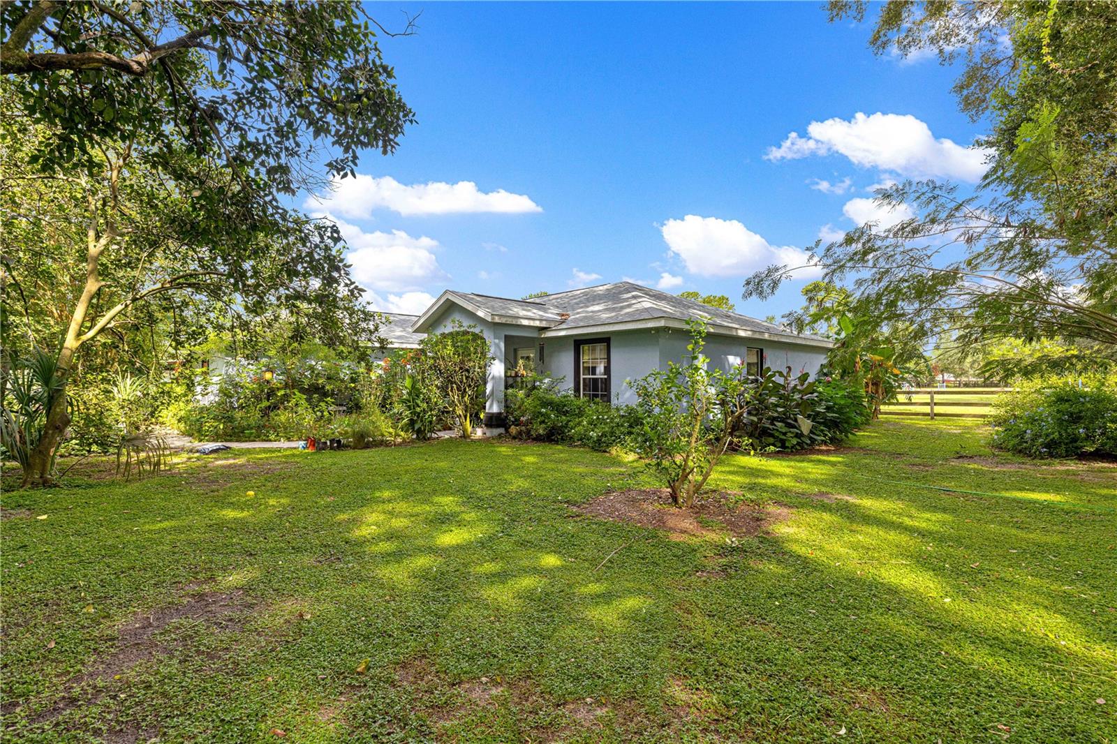 NEWLY REDUCED PRICE! Welcome to this beautiful 3 bedroom, 2 bathroom home nestled on almost 5 acres. Perfectly suited for equestrian living. Just 20 minutes from Florida horse park and the riding trails. Only 35 minutes from the world equestrian center! This property offers a rare combination of comfort, functionality, and country charm. The home features a spacious layout ideal for both everyday living and entertaining, with a beautiful pool providing a relaxing retreat. This property includes five well-maintained paddocks, two barns, and a total of seven stalls. This is an ideal setting for those seeking a peaceful lifestyle with convenient access to equestrian amenities.
