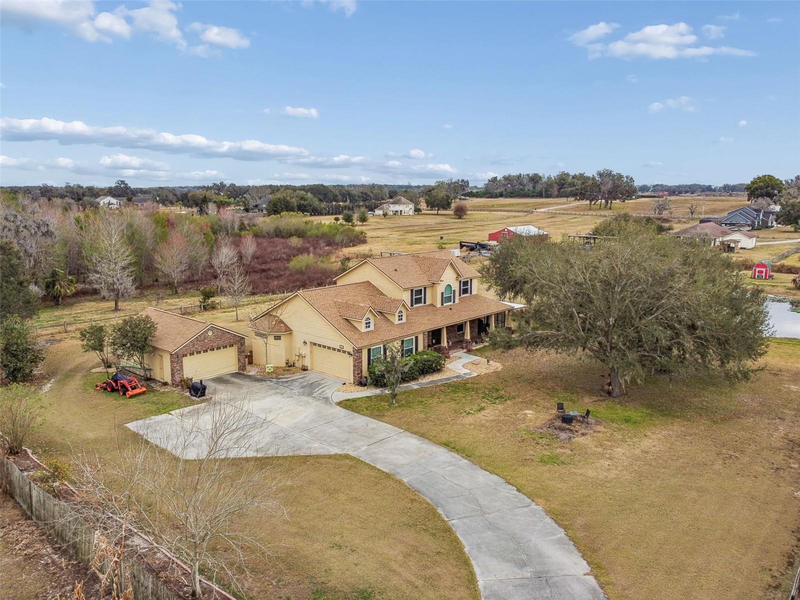 Discover the perfect blend of space, comfort, and country charm with this exceptional 4-bedroom, 2.5-bathroom two-story home situated on just over 2.7 private acres.

Built in 2006, this beautifully maintained residence offers 2,829 square feet of heated living space and an impressive 5,538 square feet under roof thanks to a massive porch addition—ideal for entertaining, relaxing, and enjoying peaceful views of your own backyard retreat.

The current homeowners have taken meticulous care of the property and have made numerous updates and additions, including beautifully renovated kitchen and bathroom spaces that enhance both style and functionality.

Inside, you’ll find warm bamboo and engineered hardwood flooring that flows throughout the main living areas, creating a timeless and inviting atmosphere. The spacious layout provides flexibility for both everyday living and hosting guests, with generously sized bedrooms and thoughtfully designed common spaces.

Step outside and experience everything this property has to offer. Enjoy approximately 100 feet of water frontage along your private pond—perfect for quiet mornings, fishing, or simply unwinding by the water. The expansive acreage offers room to roam, garden, or expand, and even includes a chicken coop for those seeking a touch of homestead living.

Car enthusiasts and hobbyists will appreciate the rare 4-car garage, providing abundant space for vehicles, storage, or a workshop. Additional features include a durable shingle roof, septic system, and dual HVAC units for efficient climate control throughout the home.

With its generous square footage, scenic pond frontage, and versatile outdoor space, this property delivers the privacy of country living while offering all the modern comforts you need. Don’t miss the opportunity to make this one-of-a-kind property your own.