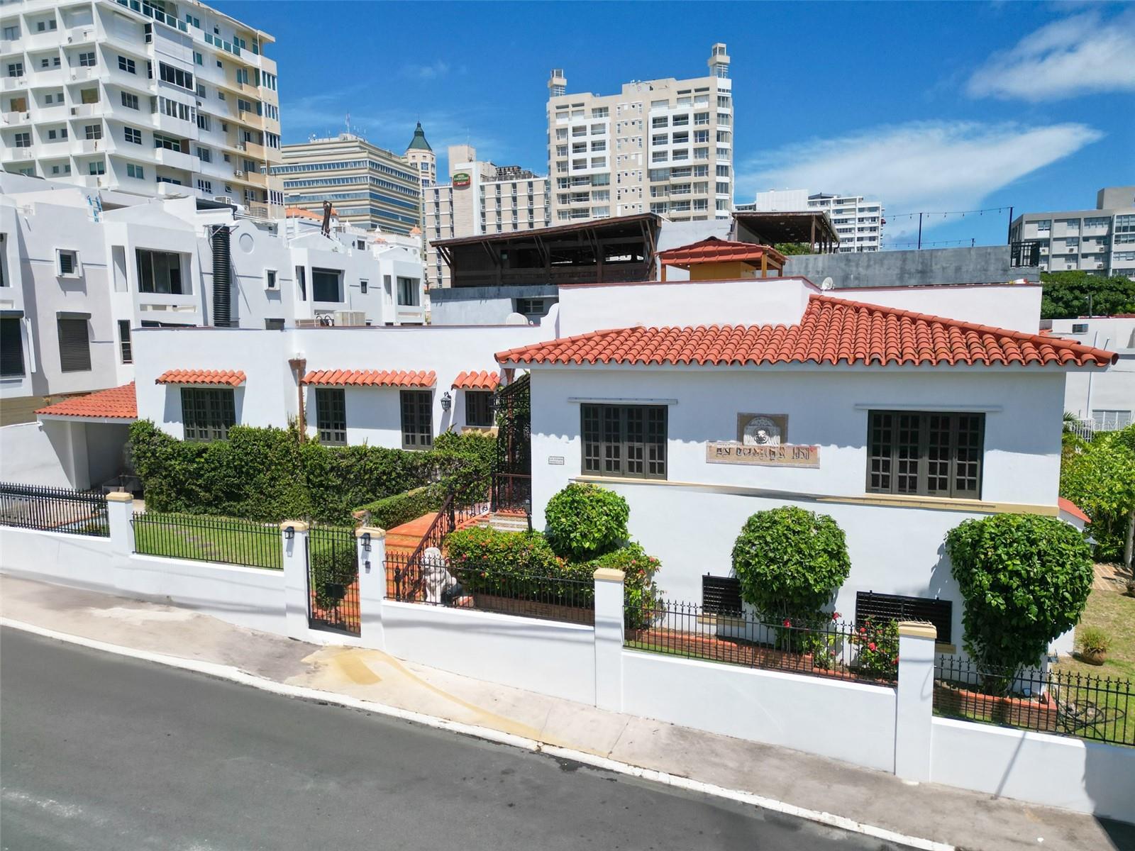 Located on one of the most charming and quiet residential streets in historic Miramar, this fully remodeled Spanish Colonial home offers timeless elegance with modern comfort. Sitting on a corner lot, the two-level residence spans approximately 4,500 square feet and features six bedrooms and four and a half bathrooms. Thoughtful renovations include a redesigned kitchen with high-end appliances and custom wood cabinetry, updated bathrooms, new floors, windows, and roof. Original architectural elements such as arched wrought-iron doors and terracotta tile details have been carefully preserved to honor the home’s heritage.

Ideal for entertaining, the property boasts a large covered terrace with a built-in bar and lounge area, plus a beautifully tiled plunge pool with tropical landscaping. Additional features include a full-power generator, water cistern, inverter A/C units (5-ton), and a four-car covered garage. Just steps away from Condado and top restaurants, this is a rare opportunity to own a classic yet turnkey home in one of San Juan’s most coveted neighborhoods.