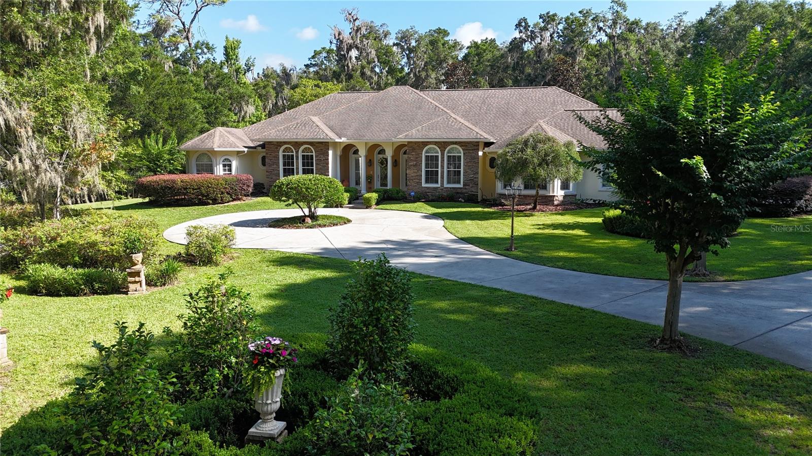 Luxury Equestrian Living in Turning Hawk Ranches

Nestled beneath a canopy of majestic live oaks, on 5+/- private acres, this custom-built estate offers an exceptional blend of luxury, privacy, and equestrian-friendly living within the gated community of Turning Hawk Ranches. Residents enjoy direct access to the Florida Greenways and Trails, providing miles of scenic riding, hiking, and biking trails, while remaining conveniently located near the Florida Horse Park, World Equestrian Center, shopping, dining, and medical facilities.
Spanning 4,686 square feet of thoughtfully designed living space, the residence showcases timeless architecture, quality craftsmanship, and an ideal balance of formal and casual living areas. A grand foyer welcomes guests into elegant interiors filled with natural light and picturesque views of the surrounding property. The heart of the home is the beautifully appointed kitchen featuring custom maple cabinetry, an expansive center island, generous workspace, and a sunny breakfast area overlooking the grounds. Designed for both everyday living and entertaining, the kitchen flows seamlessly into the spacious family room, where coffered ceilings, an Italian marble fireplace, and French doors create a warm and inviting atmosphere while opening to the expansive verandah.
The private owner’s retreat serves as a luxurious sanctuary, complete with tranquil views, a spa-inspired bath, and an oversized custom closet. A dedicated office with custom-built-in cabinetry provides an ideal work-from-home space, while the theater and media room offers the perfect setting for movie nights, sporting events, or gathering with family and friends. 
The thoughtfully designed split-bedroom floor plan ensures privacy for all, featuring three additional spacious bedroom suites, each with its own private bath. Throughout the residence, refined architectural details, including crown molding, plantation shutters, custom millwork, and tile flooring, reflect the home’s enduring elegance and attention to detail.
Outside, mature landscaping and peaceful surroundings create a private retreat where indoor and outdoor living blend effortlessly. Whether enjoying quiet mornings on the verandah, entertaining guests, or simply taking in the beauty of the acreage, the property offers a lifestyle defined by comfort and tranquility. Additional features include a partial-house generator, water filtration and softening systems, irrigation, and security systems for added peace of mind. Offering the rare combination of luxury, acreage, direct trail access, and an exceptional location, this remarkable estate represents one of Ocala’s finest opportunities for those seeking refined country living in the heart of horse country.