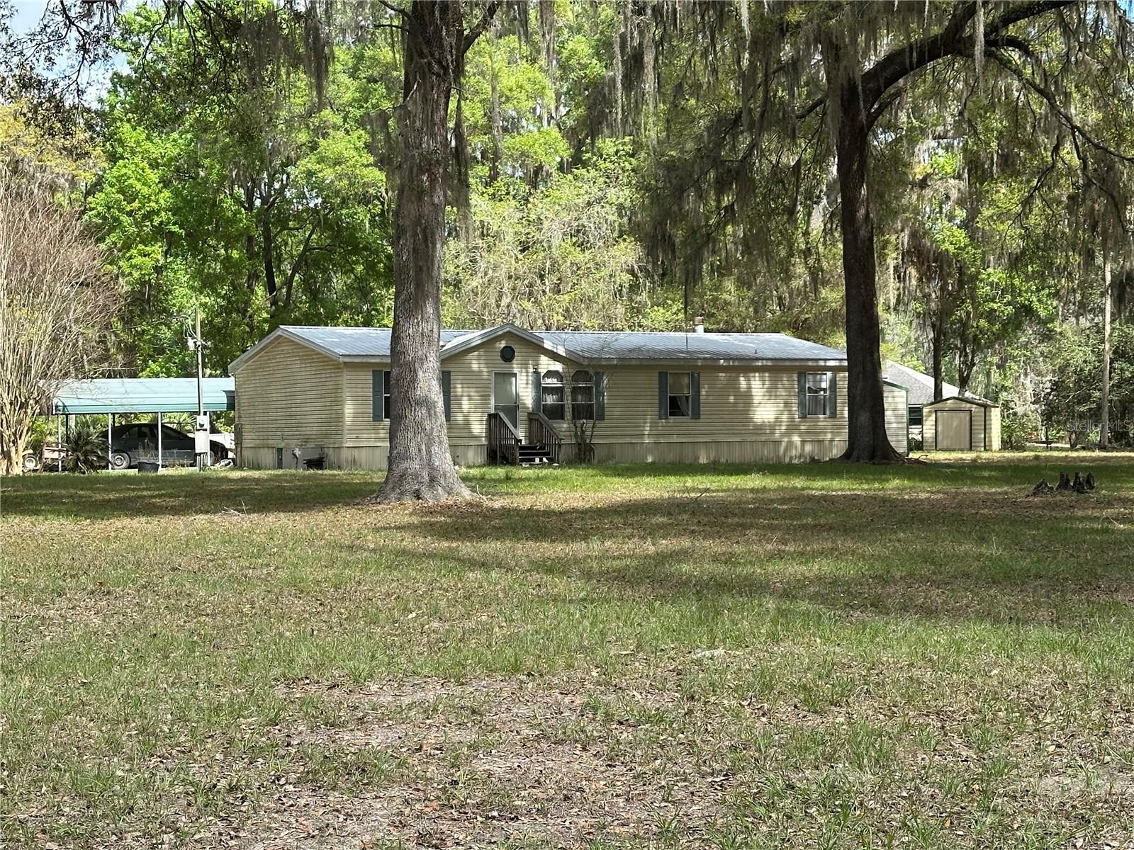 Set on 3 beautiful acres in Citra, this 3 bedroom, 2 bath mobile home offers space, privacy, and plenty of potential. Built in 1999, the home is ready for some TLC, making it a great opportunity for a buyer looking to add their own touches and create value. The property includes three sheds, providing excellent storage for tools, equipment, hobbies, or outdoor gear. With room to spread out, enjoy country living, start a small homestead, or simply take advantage of the extra land. Conveniently located at 2351 NW 186th Lane, this property offers a peaceful setting with endless possibilities.