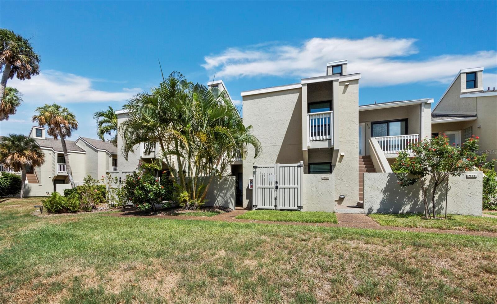 Move-in-ready condition, ground-floor bayside condominium with Sarasota Bay views and deeded private Gulf beach access in the sought-after Banyan Bay Beach Club! Discover effortless coastal living in this beautifully updated 2-bedroom, 2-bath residence offering 1,155 square feet on the bayside of Longboat Key. Thoughtfully renovated throughout, this inviting home features new luxury vinyl plank flooring, new kitchen appliances, updated bathrooms with new vanities, and a bright, open floor plan designed for comfortable island living. Enjoy  Sarasota Bay views from the living room, primary bedroom, and private rear patio. Step directly from your patio onto the beautifully landscaped lawn, where you can enjoy your morning coffee, watch boats and dolphins pass by, observe abundant coastal wildlife, and welcome beautiful Florida sunrises. The convenient ground-floor location offers effortless access and seamlessly blends indoor and outdoor living. Residents of this pet-friendly community enjoy the best of both worlds with deeded private Gulf beach access and outstanding  amenities, including a heated pool, clubhouse, pickleball, tennis, fishing pier, kayak storage and launch, and assigned parking. Whether you enjoy boating, kayaking, fishing, shelling, or relaxing on the beach, this community offers the quintessential Longboat Key lifestyle. Ideally located near championship golf, waterfront dining, marinas, boutique shopping, St. Armand's Circle, and downtown Sarasota, this exceptional residence is perfect as a primary home, seasonal retreat, or investment opportunity. Don't miss this rare opportunity to own an updated, move-in-ready, bayside condominium with Sarasota Bay views, deeded private Gulf beach access, and the relaxed elegance of island living.