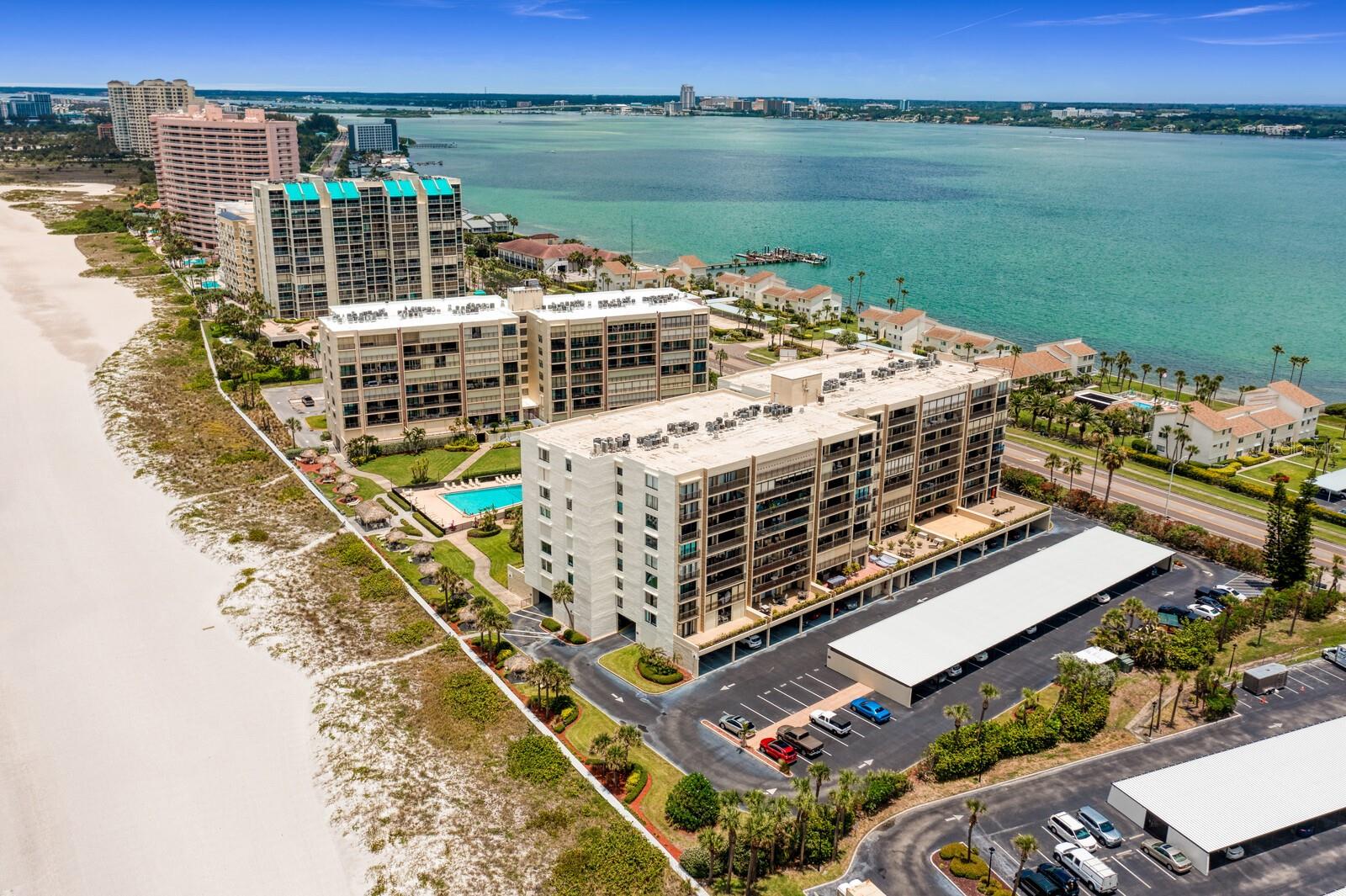 Experience the ultimate beachfront living in this exquisite Sand Key PENTHOUSE Condo situated in Sand Key Beach, Florida. Offering stunning views of the Gulf and Intracoastal Waterway, this renovated 8th-floor unit offers over 1,600 square feet of luxurious space and TWO (2) covered parking spaces, one underbuilding and one carport. Three spacious bedrooms, two full baths, and an inviting contemporary ambiance with artistic décor. Indulge in relaxation on the expansive 26-foot deck, where you can marvel at breathtaking sunsets over the Gulf of Mexico or witness the serene sunrise over the Intracoastal Waterway. The recently upgraded hurricane-rated sliding doors and windows provide both security and tranquility. This impressive residence, named Take it Easy, comfortably accommodates up to six guests. The fully equipped kitchen showcases stunning granite countertops and breakfast bar, inviting you to prepare delicious meals with ease. This beachfront building offers direct access to the soft white sandy beach, where you can stroll along the shoreline or wade into the tranquil ocean waters. Embrace the gated community's serene atmosphere, adorned with beautifully landscaped grounds, a large, heated pool, tiki huts, and a workout room. Conveniently located minutes to the Shoppes on Sand Key. There you’ll find a variety of dining and shopping options, including the renowned Columbia restaurant, cozy breakfast spots, an ice cream parlor, a pizza place, boutique clothing stores, and even a nail salon. Should you wish to explore further, hop on the Trolley stop conveniently located in front of the Condo, offering access to a plethora of restaurants, shops, and exciting activities on Clearwater Beach. Sorry no smoking and no pets per HOA rules. Don't miss out on this extraordinary opportunity—call today for more details and to secure your dream beachfront getaway. **BE SURE TO SEE ZILLOW 360 IN VIRTUAL TOUR LINKS** Available August 12, 2026 through June 14, 2027 - 3 MONTHS MINIMUM, 6+ months preferred. In Florida, any lease less than 6 months is subject to 13% tourism taxes.