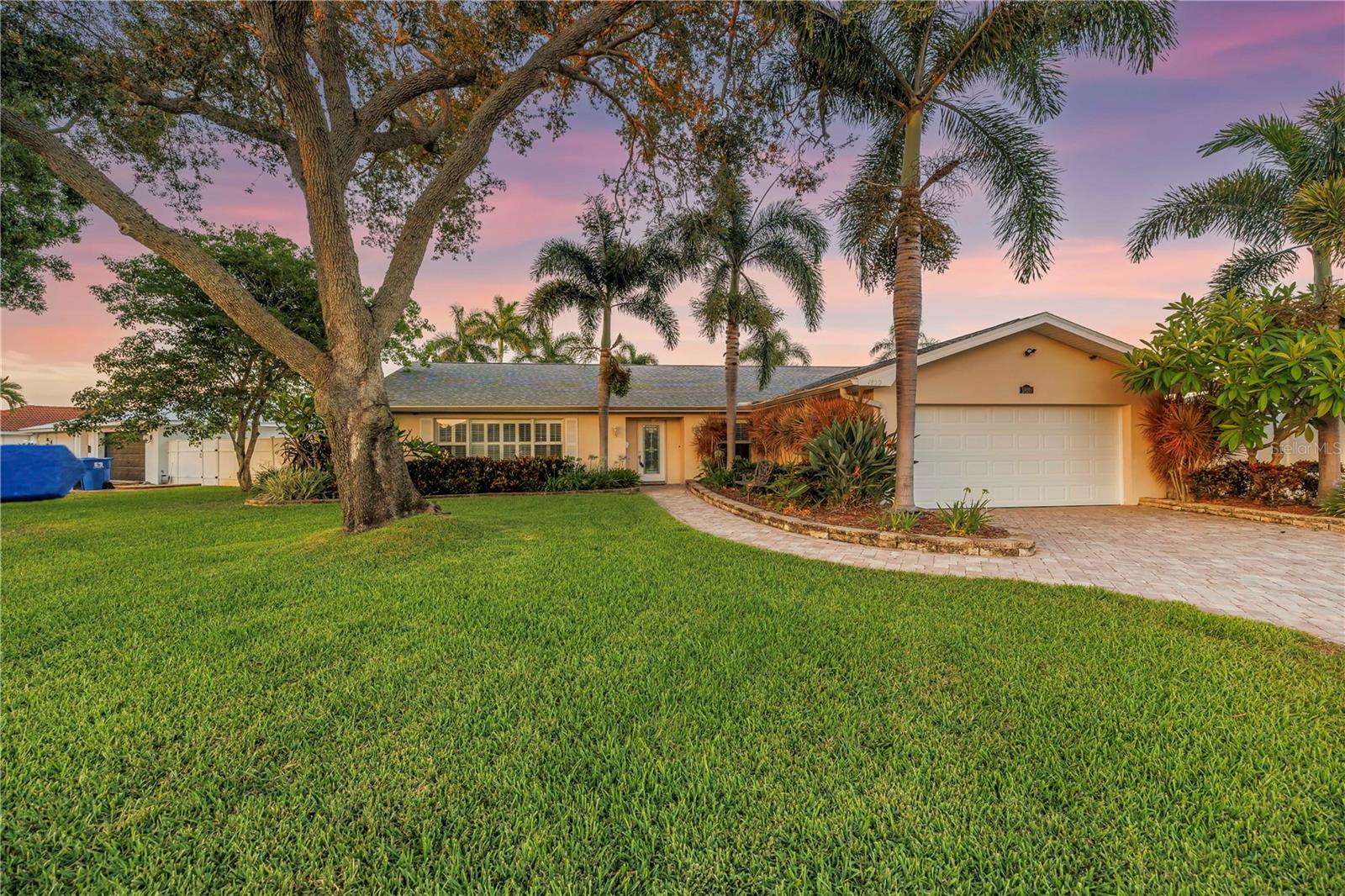 This wonderful waterfront pool home is nestled in the very desireable Tanglewood neighborhood of NE St Petesrburg. Featuring 4 bedrooms (split bedroom plan,) 2 baths, formal living room & dining room plus a very roomy family room. Both the primary bedroom and the second bedroom offer access & views to the water and pool area. The kitchen has granite countertops, stainless appliances (new refrigerator & dishwasher in 2024,) wood cabinents and a large walk-in pantry. The main living area of the home has crown molding and plantation shutters. Walk out back to your covered porch and pool area which are both perfect for entertaining and enjoying the Florida lifestyle. The pool is heated and also has a heated built-in spa. New roof & water heater in 2024. You have unobstructed access to Tampa Bay right from your own dock and 9K lbs Hi-Tide boat lift via a deep saltwater canal. The boat lift pilings are wrapped to protect them. The yard is fenced with PVC fencing and there's plenty of room on the north side of the home to park your boat trailer or smaller RV. Tanglewood offers a private waterfront setting but is just minutes to some of the best restaurants in the area, shopping, parks/recreation and very easy access to I-275/Gandy and Tampa airport.