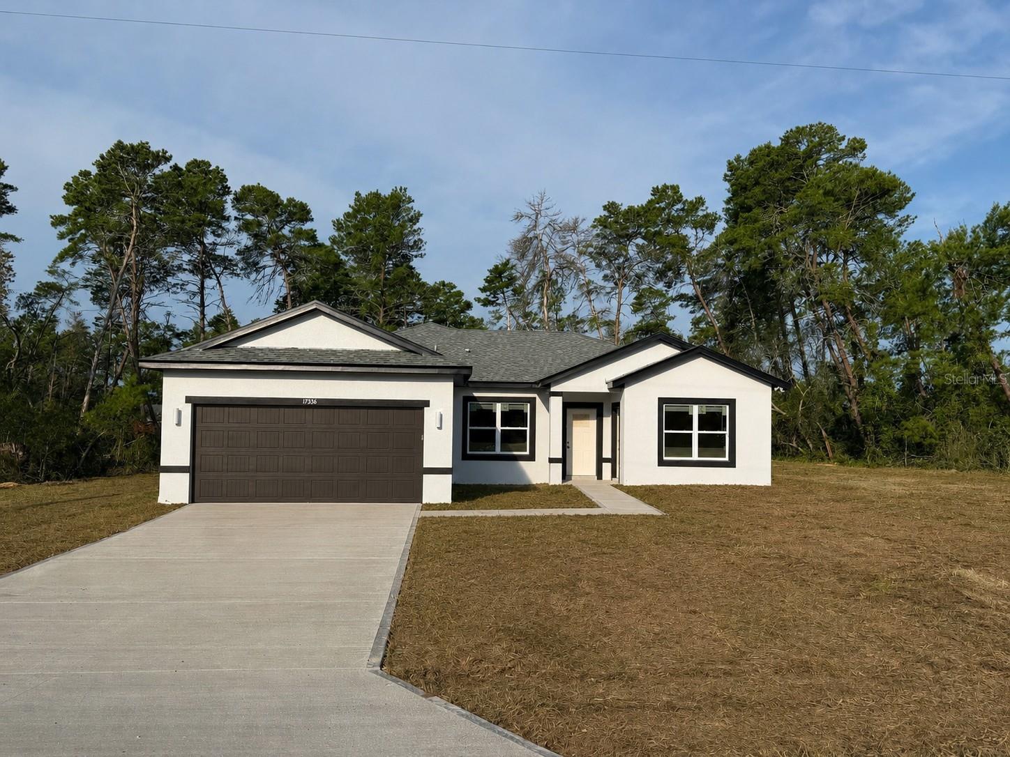 BRAND NEW 2026 HOME ON A RARE HALF-ACRE LOT (0.50 ACRES) WITH A PRIVATE-ENTRANCE IN-LAW SUITE IN MARION OAKS! This stunning newly constructed home combines modern living with excellent income potential, featuring a separate in-law suite with 1 bedroom, 1 bathroom, a kitchen, and its own washer and dryer, making it perfect for extended family, guests, or rental income. The open-concept layout is filled with natural light and luxury vinyl flooring throughout, creating a warm and inviting atmosphere. The spacious primary suite features a luxurious bathroom with a dual-head walk-in shower and dual vanities, offering both comfort and convenience. A smart key entry system adds security and ease of access. Situated on an oversized half-acre lot, there is plenty of room to enjoy the outdoors, add a pool, or create your ideal backyard. With a builder's warranty included for added peace of mind, this property is ideal for families seeking flexibility or investors looking for a promising opportunity.