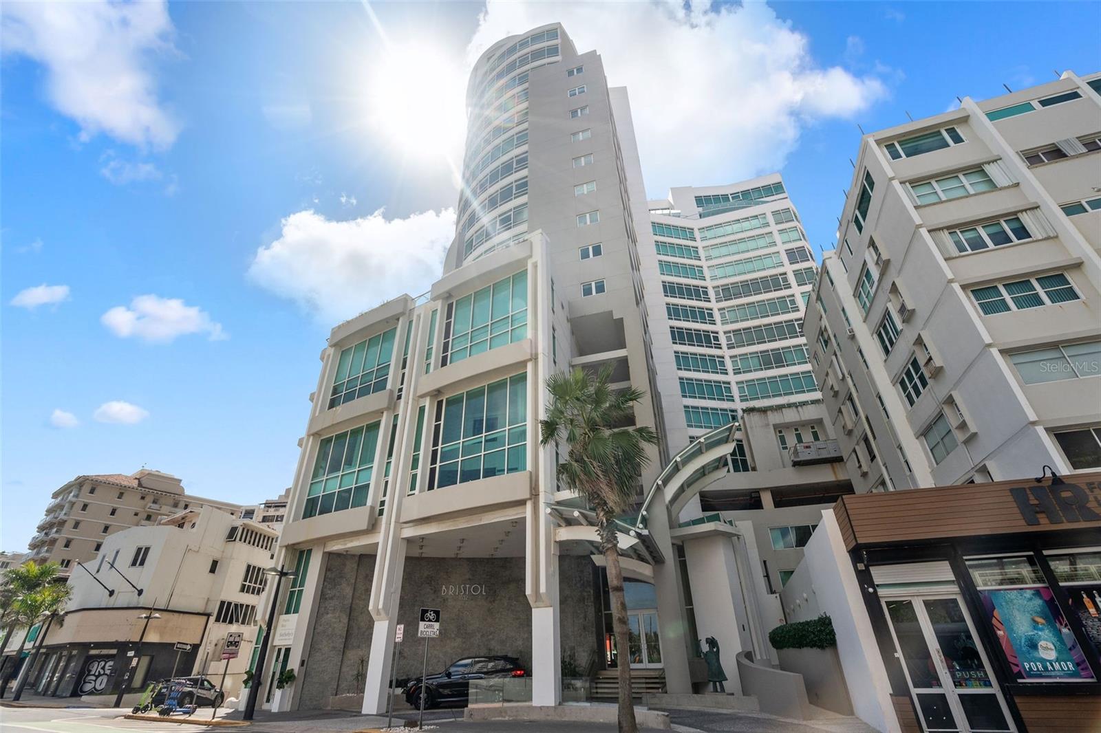 Soaring high above Condado’s shimmering coastline, this exceptional residence at The Bristol redefines luxury living with its unmatched elegance and panoramic ocean-to-lagoon vistas.
Located on the 9th floor of the Bristol Condominium, this exquisite residence captures sweeping views of both the Condado Lagoon and the Atlantic Ocean from every window. Perfectly positioned to embrace Condado’s coastal sophistication, this home offers a front-row seat to some of San Juan’s most breathtaking sunsets and sparkling skyline views. Encompassing approximately 3,291 square feet, the home features two spacious bedrooms—easily convertible to three—three full bathrooms, and a powder room. The expansive open-concept layout seamlessly connects the living, dining, and kitchen areas, creating an atmosphere of effortless elegance and comfort. The primary suite offers a private sanctuary with glass windows framing tranquil lagoon vistas, complemented by a luxurious bathroom with double sinks, bathtub, separate shower, and a generous walk-in closet. Wake up each morning to the shimmering reflections of the lagoon and unwind in complete serenity as the city lights dance across the water at night. Refined finishes throughout include marble flooring, wood cabinetry, fascias, and ceiling-to-floor glass windows in the entrance, living, dining, areas that invite natural light and frame the captivating ocean and lagoon views, along with private elevator access. The residence also includes one storage room & three covered parking spaces, providing convenience and security for its residents. The Bristol is recognized as one of the most distinguished residential addresses in Condado and stands among one of the most luxurious buildings, offering the finest in urban resort-style living. Renowned for its discreet elegance and refined ambiance, The Bristol caters to a selected community that values location, views, privacy, comfort, and world-class service. Amenities include 24-hour security and concierge service, fitness center, resident’s lounge and game room, service elevator, full power generator, and water cistern. Ideally situated at 1052 Ashford Avenue in the heart of Condado, The Bristol places you steps from world-class destinations including the Condado Vanderbilt and La Concha Hotels, La Ventana al Mar Park, St. John’s School, Ashford Presbyterian Hospital, fine dining, boutiques, and the area’s celebrated beachfront promenade. The Bristol is more than a residence—it’s a statement of elegance, privacy, and timeless coastal sophistication. A rare opportunity to own one of Condado’s signature homes, where every detail speaks of luxury, every view inspires, and every day feels extraordinary.
Discover this unique residence in person—schedule your private showing today!