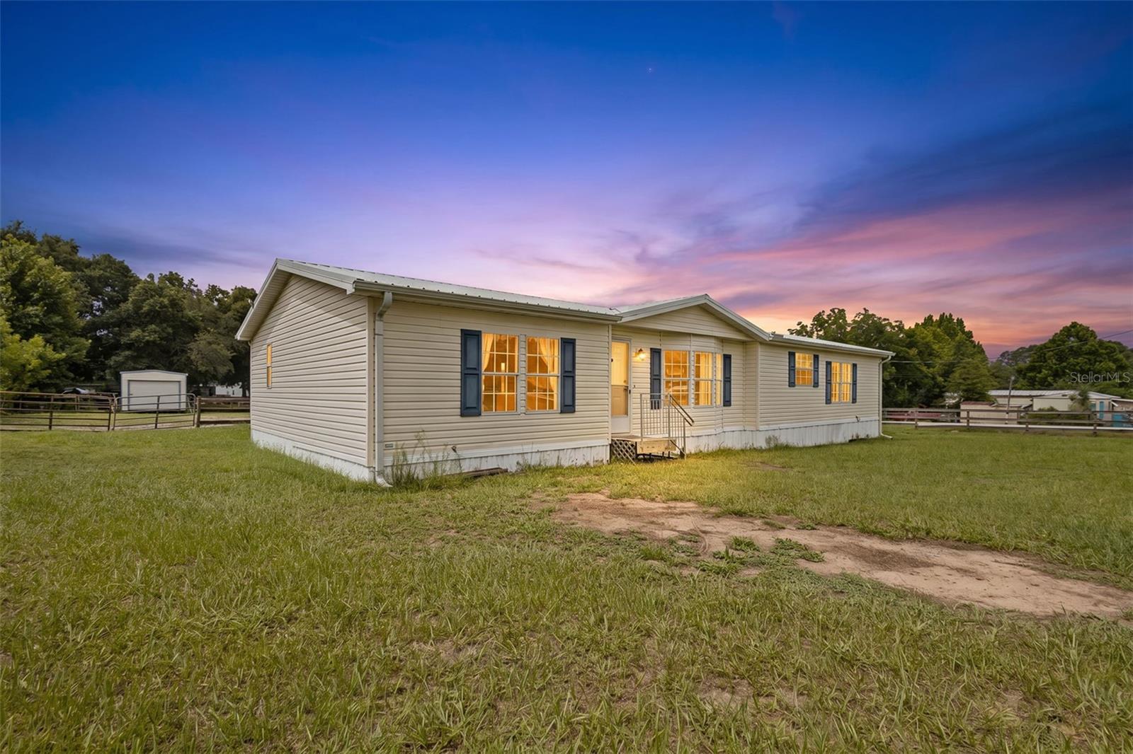Exceptional equestrian opportunity in the highly sought-after Ocala Thoroughbred Acres! Situated on a fully fenced 1-acre corner parcel less than 2 miles from the World Equestrian Center (WEC), this 3-bedroom, 2-bath Skyline manufactured home offers the perfect combination of comfort, convenience, and horse-friendly amenities. Featuring tape and texture drywall throughout, wood burning fireplace, and a walk-in pantry. And while the home does have carpet and vinyl flooring the seller is offering a flooring credit at closing! Designed for equestrians, the property features a barn complete with a dedicated feed room/tack room, along with two paddocks that provide ample space for your horses. Enjoy the unique benefit of direct access to the adjoining vacant land, allowing for convenient trail riding right from your property. Whether you’re looking for a full-time residence, seasonal getaway, or investment property in the heart of Ocala’s horse country, this location is second to none. Just minutes from WEC, shopping, dining, and everyday conveniences, this property offers the equestrian lifestyle you’ve been searching for. Schedule your private showing today!