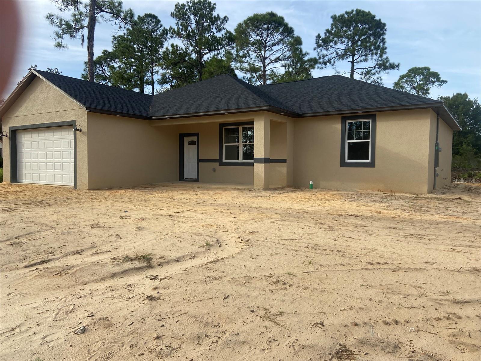 New construction in the heart of Sebring in the desirable area of Sebring Country Estates.  Spacious split floor plan, 3/2/2 block home. Open concept with great room featuring a 10 foot high  ceiling, tray ceiling, recessed LED lighting & prewired for ceiling fan. All other ceiling are 9 ft high. Home features, porcelain tile  throughout.  Spacious kitchen opens to great room. Kitchen features granite counter tops, kitchen island, stainless steel range, built-in microwave, dishwasher, farm house sink with matte black fixtures and white wood cabinets. All drawers are soft close. Kitchen features a nice size pantry.Kitchen is open to the dining area & features black matte drop lighting and double doors that lead to your spacious covered back lanai with columns. Master Suite is spacious and prewired for a ceiling fan, features an in-suite walk in closet with wire shelving. Also features an in-suite master bath with double vanities, granite counter tops, walk in ceramic tile shower with rain shower head. The other 2 bedrooms are located on the other side of the home. Bedrooms  are prewired for ceiling fans. There is a full bath in the hallway between the 2 bedrooms.  This bath has granite counter top & tiled tub/shower combo. This bath is roomy with plenty of room for accessories.  Home has a double garage with attic access & automatic smart garage door opener .This home has a covered open front porch as well as a large covered back lanai with columns. Home has LED lighting under the eves.  The yard features an irrigation system. The septic tank is in the front yard so the back yard has space for your pool/spa. Great size back yard.  Minutes from Walmart, Walgreens, Publix, hospitals & US Hwy 27. Sebring International Raceway is 13 miles, approximately 70 miles from Punta Gorda Airport, 80 south of Orlando International Airport, 97 miles south of Tampa International Airport , 160 miles from Miami and about 70 miles to east or west coast of Florida. Come live the dream in Sebring!