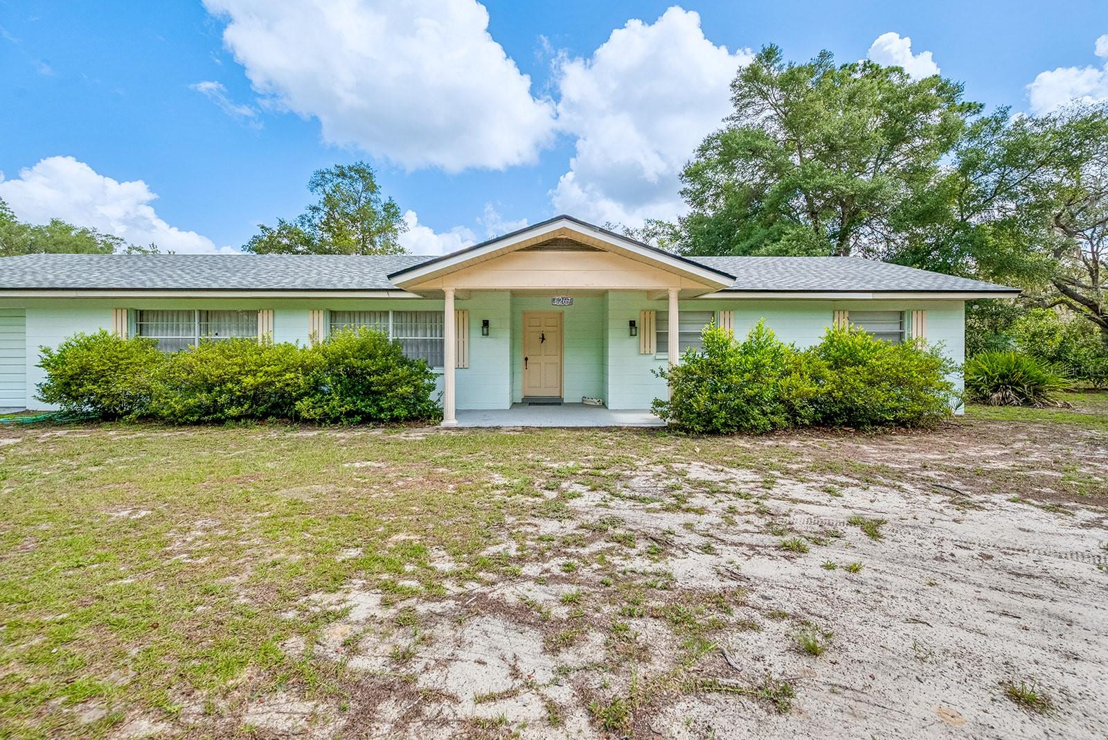 Welcome to this well-maintained 3-bedroom, 2-bath concrete block home offering comfort, versatility, and peaceful country living. A standout feature of this property is the detached efficiency apartment, complete with a studio-style floor plan, kitchenette, full bathroom, walk-in closet, and its own private two-car carport--perfect as an in-law suite, guest quarters, home office, or income-producing rental. The main home features a spacious living and dining room combination, a functional kitchen, and an additional family room centered around a cozy gas fireplace, providing plenty of space for everyday living and entertaining. The kitchen and bathrooms showcase beautiful, handcrafted wood cabinetry, adding warmth and character throughout the home. Major updates include a new roof on the home, efficiency apartment, and shed/carport in 2025, along with a new well installed in 2024, offering added peace of mind for years to come. Nestled just off the beaten path, this property provides the tranquility of country living while remaining just a short drive from shopping, dining, schools, and other everyday conveniences. AT&T Fiber internet is available, making it easy to work from home or enjoy high-speed connectivity.