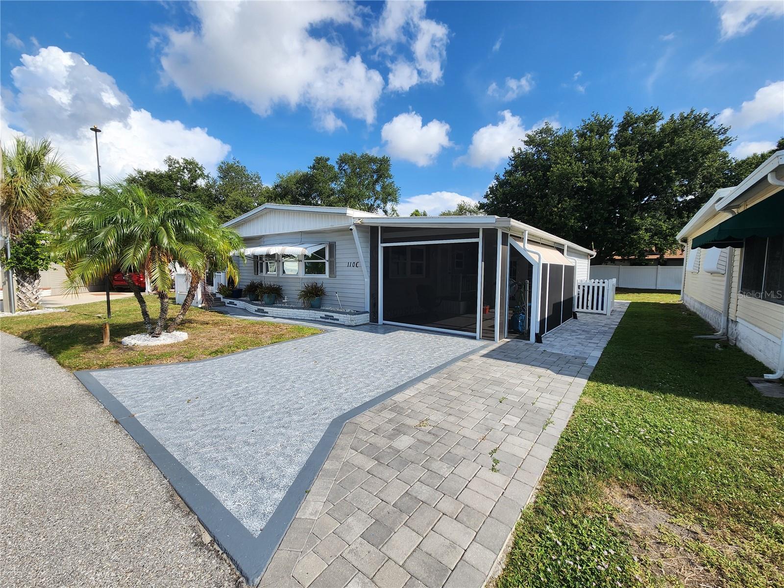 NO LOT RENT ! FURNISHED! NEW A/C 2025! Welcome to Palm Lake Estates, one of the area's most desirable active 55= communities, where you own the land and enjoy a low-maintenance fee! This beautifully maintained, move-in-ready two-bedroom, two-bath home has all the updates buyers are looking for. The remodeled kitchen features granite countertops, a pantry with convenient pull-out drawers, and abundant cabinet space. Automatic shades throughout the home, including the Florida room with its own A/C, add comfort and convenience, while easy-care tile and laminate flooring make everyday living effortless. Major updates include newer windows, a roof only five years old, a brand new A/C installed in 2025, and a water heater just three years old, giving you peace of mind for years to come. Relax on the screened front porch, unwind in the spacious screen lani, or enjoy the large workshop, which is perfect for hobbies, crafts, storage, or a handyman's dream workspace. Palm Lake Estates is known for its active lifestyle, friendly neighbors, clubhouse, heated pool, and shuffleboard- all just minutes from shopping, restaurants, medical facilities, and the beautiful Gulf beaches. Why pay lot rent when you can own your land? Bring your suitcase, move right in, start living.