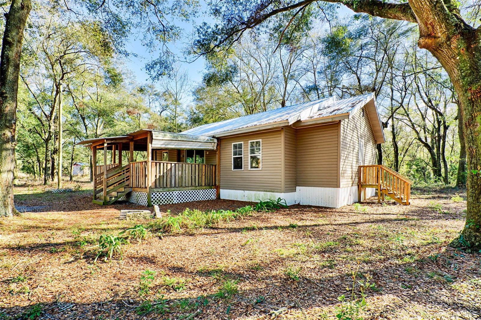 Your house calling for you!!! Fully remodeled   3-bedroom, 2-bathroom home sits on almost  8 acres, offering a lot of Space and Privacy. NO HOA!! Home features a lot of upgrades that were completed within last 2 years like new  roof,  septic tank and Drain system, HVAC system, well, New flooring, walls, paint, electrical and much more. Next lot 7,92  acres is also available for purchase, offering the potential to expand your property. 
Enjoy easy access to world-famous springs, perfect for swimming, kayaking, and outdoor adventures. Located just 25 minutes from High Springs, 30 minutes from Alachua, and 45 minutes from Gainesville, you’ll have the best of both seclusion and accessibility. Don’t miss this rare opportunity—schedule your showing today!