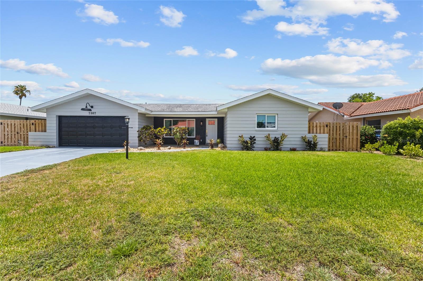 Welcome to your like-new coastal haven in West Bradenton! This stunning home has been completely remodeled from top to bottom, thoughtfully transformed into a true 3-bedroom residence that delivers new-construction feel without the new-home price tag. From the moment you step inside, you will love the light, bright, and airy ambiance anchored by beautiful, seamless wood-look tile flooring, fresh professional drywall texturing (walls and ceilings), new doors and trim and elegant recessed lighting that runs throughout the entire home. The heart of the home is a fully upgraded kitchen featuring pristine white shaker cabinetry accented with modern brass hardware, premium solid-surface countertops, a stylish geometric tiled backsplash, and a brand-new stainless-steel appliance package. The open floor plan flows effortlessly into the dining and living spaces, perfectly complemented by a large bonus flex-room/home office/3rd bedroom enclosed by massive sliding glass impact doors that overlook the outdoors. Both bathrooms have been exquisitely renovated with high-end modern vanities, chic gold fixtures, and custom tile work including a stunning green mosaic tile walk-in shower.
Every major mechanical and structural update has already been done for ultimate peace of mind: brand-new high-impact hurricane windows and doors throughout, a new AC compressor and air handler, new blown-in insulation for low utility bills, a newer roof, a professional-grade garage floor coating, and new front yard sod and irrigation. Best of all, a brand-new $22,000 plumbing/sewer lining was completed this year!

Step outside to discover a sprawling, fully fenced backyard?a massive blank canvas ready for a pool, gardening, or your dream outdoor entertainment oasis. To help bring your vision to life, the seller is offering a generous $8,000 credit at closing for immediate improvements.  A brand-new garden shed, ideal for additional storage is included. Location is everything! This property is completely outside of a flood zone and sits just 5.6 miles (a quick 12-minute drive) from the sugar-sand shores of Manatee County Public Beach on Anna Maria Island. You are also just minutes away from the new Target, Publix, Bonefish Grill, HomeGoods, and premier local dining. Optional HOA for your benefit, but not a requirement.  The sellers are also including the majority of the furnishings and yard equipment with the sale. Whether you are looking for a turn-key primary residence, a seasonal Florida retreat, or a premier investment property, this West Bradenton gem is ready for you. Schedule your private showing today!