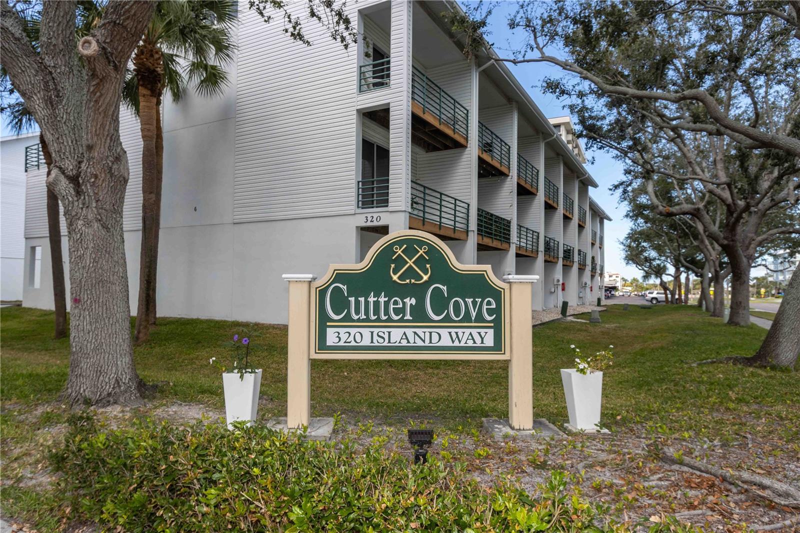 Welcome to your paradise in Cutter Cove, a serene and highly sought-after townhome community on Island Estates—just minutes from the world-famous Clearwater Beach. With a motivated seller and aggressive pricing, this is a rare opportunity to secure exceptional value in one of the area’s most desirable waterfront communities. Rare investment opportunity on this possible income-producing rental property allowing 30-day minimum rentals with no ownership waiting period before you can begin leasing.  This property offers some of the lowest HOA fees on Island Estates.  This beautifully updated, three-level residence offers resort-style living with timeless coastal elegance. The spacious, expanded kitchen—approximately 20% larger than standard units—provides enhanced functionality and flow, perfect for both everyday living and entertaining. The primary suite is a private retreat featuring dual closets, a spa-inspired bath with a jetted tub, and a striking wooden spiral staircase leading to a versatile loft—ideal for a home office, media room, or play space. A huge balcony with sliding glass doors welcomes in the island breeze, seamlessly extending your living space outdoors. A second upstairs bedroom offers its own full bath and walk-in closet, while the main-level bedroom is thoughtfully configured as an office with built-in desk and shelving (which convey) and an adjacent full bath. Elegant polished marble flooring enhances the living area, flowing effortlessly to a private patio perfect for enjoying the coastal air. Additional highlights include updated bathrooms, crown molding, wood stairs with wrought iron railings, and abundant glass doors for a light, open feel. Major upgrades include a brand-new Trane A/C system, hurricane shutters, and a king-size Rheem water heater. The oversized tandem two-car garage features built-in storage cabinets and extra closet space. French doors with screen sliders open from the ground level to a private patio—ideal for relaxing or entertaining. Cutter Cove residents enjoy resort-style amenities including a sparkling pool and hot tub spa surrounded by tiki huts. With convenient access to shopping, dining, and the beach, this home delivers the very best of the Island Estates lifestyle—now attractively priced for a timely sale.