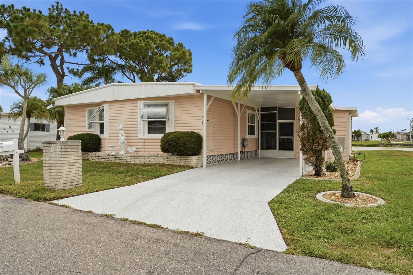 Lakefront Triple-Wide Home in Harbor Cove's Premier 55+ Community! Experience peaceful waterfront living in this spacious triple-wide home overlooking beautiful Imperial Lake. Enjoy stunning sunset views from the comfort of your home or relax in the large screened lanai while taking in the tranquil lakefront setting. Designed with an open floor plan, this residence features two extra-wide sections, creating exceptional living space throughout. The bright living room showcases a wall of windows that fills the home with natural light while framing picturesque lake views. A formal dining area with built-in display cabinetry and additional storage provides an elegant space for entertaining. Just off the living room, the media room features an electric fireplace and sliding glass doors that open to lake views, creating the perfect space to unwind. The well-appointed kitchen offers abundant cabinet and counter space, along with a convenient breakfast bar. Adjacent to the kitchen, the dinette area provides an ideal setting for casual meals and everyday living. The spacious primary suite includes two walk-in closets and a private ensuite bathroom. A generously sized guest bedroom offers ample closet space, while the second bathroom is thoughtfully designed with direct access from both the guest bedroom and dinette area, providing added privacy and convenience.
Additional features include a large storage shed with a workbench, laundry area, and utility sink.

Recent Updates: 2025 Metal Roof, 2024 New Ductwork, 2024 New Washer & Dryer, 2023 Carport Replacement, 2023 Epoxy-Coated Driveway, 2013 Thermal Windows, Newer Kitchen Subfloors and Flooring, Newer Carpet.
The home is being sold mostly furnished—simply bring your bedroom furniture and start enjoying the Florida lifestyle. Conveniently located near the clubhouse and community amenities including a pool and spa, fitness center, library, marina, bocce ball, shuffleboard, tennis courts, and pickleball courts. The marina provides direct boating access to the Myakka River, Peace River, Charlotte Harbor, and the Gulf.

Ideally situated near shopping, dining, Gulf beaches, spring training facilities for the Tampa Bay Rays and Atlanta Braves, Warm Mineral Springs, and more! This exceptional lakefront property offers the perfect combination of comfort, convenience, and active Florida living—whether as a full-time residence or seasonal retreat.