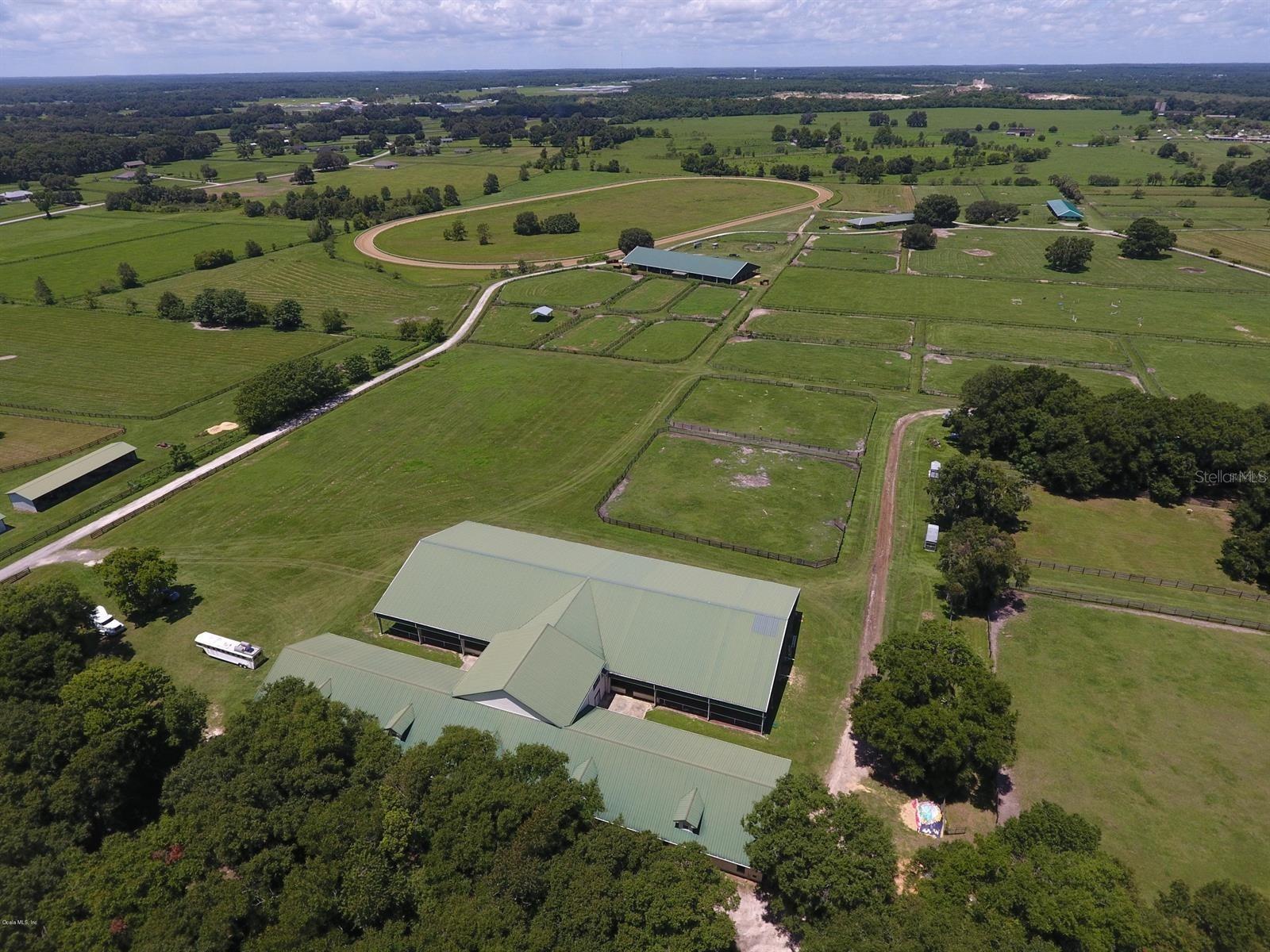 Gorgeous one of a kind 316+ acre farm close to town! Land and Buildings in good shape.  Peninsula Farm is perfect for training/breeding/racing!  In fact, it boasts a 5/8 mile track that is known to be one of the finest in Marion County!  Peninsula Farm has raised and trained iconic horses like Kentucky Derby winner Silver Charm along with the highest priced race horse ever sold in auction.  This 9 parcel farm has 14 barns/223 stalls/breeding shed and a covered arena with a viewing deck!  90 paddocks and is a fully rented income producing facility.  Many of the structures have new metal roofs.  There are 3 residences, perfect for caretakers and trainers or even as a winter show season rental/s.  The farm is fully fenced and more importantly sits high and dry on a scenic hillside located conveniently on Highway 441! Just two short miles from the newly opened Iron Lake Country Club (formerly Adena); and only 12 miles to WEC and 15 to HITS!!!  Here is a great development opportunity also a useful farm with rental income and cash flow history!