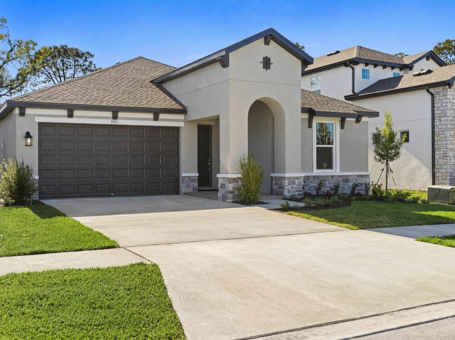 Welcome to this beautifully upgraded home in the highly desirable Hidden Creek community, offering the perfect blend of modern design, comfort, and functionality. With no CDD fees and low HOA, this nearly new home presents exceptional value in a prime location.

This 3-bedroom, 2-bathroom home features a thoughtfully designed split-bedroom layout, ideal for both privacy and everyday living. From the moment you step inside, you’re greeted by an abundance of natural light, elegant tray ceilings, and 8-foot interior doors that create a bright, open feel. The foyer leads to two guest bedrooms and a full bathroom, providing a comfortable and functional space for family or visitors.

The home then opens into a spacious great room, where the living, dining, and kitchen areas flow seamlessly together—creating a warm and inviting environment for both everyday living and entertaining.

At the center of the home, the gourmet kitchen is a true standout. It features an oversized island with quartz countertops, offering ample seating and workspace for gathering, cooking, and entertaining. The upgraded cabinetry is enhanced with crown molding, soft-close drawers, and modern hardware, while the full designer tile backsplash adds a clean, custom look. A premium stainless steel appliance package includes a cooktop, built-in wall oven, designer hood, and dishwasher. The single-bowl undermount sink with a high-arc pull-out faucet adds both style and convenience. Just off the kitchen, a spacious pantry provides excellent storage and organization.

The owner’s suite is privately situated at the back of the home, creating a peaceful retreat. It features tray ceilings and a beautifully designed en-suite bathroom with dual sinks, quartz countertops, a frameless glass walk-in shower with designer tile, and a spacious walk-in closet.

Throughout the home, you’ll find luxury vinyl plank flooring in the main living areas, tile in all wet areas, and upgraded carpet in the bedrooms. Additional interior upgrades include recessed LED lighting, a two-tone paint package, upgraded baseboards, and thoughtful electrical features such as a floor outlet in the living area for a clean, modern setup.

Step outside to the extended covered lanai, a true extension of the living space, overlooking a private backyard with plenty of room to add a pool. The home is also prepped for an outdoor kitchen with plumbing and electrical already in place—perfect for creating your ideal outdoor entertaining area.

Additional features include an epoxy-coated garage floor, a larger garage door, smart home technology with a video doorbell, and enhanced curb appeal with stone exterior accents and brick paver detailing.

With over $80,000 in builder upgrades, this home is truly move-in ready.

Located just a short golf cart ride from Waterside and Lakewood Ranch, you’ll enjoy easy access to premier dining, shopping, and entertainment. Residents of Hidden Creek enjoy amenities including a sports field, playground, picnic areas, and scenic walking and biking trails.

This property offers the perfect combination of luxury, location, and lifestyle.