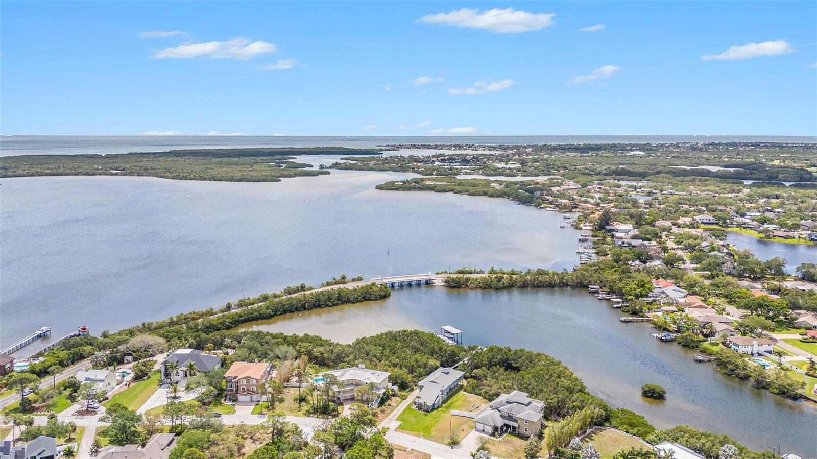 This is the LARGEST WATERFRONT lot AVAILABLE to build on in St. Pete under $1M. Live the waterfront dream on Riviera Bay in beautiful St. Petersburg! RARE HALF ACRE DOUBLE LOT with an opportunity to build your dream home. Nestled along the serene shores of Riviera Bay and surrounded by lush mangroves and tropical landscape, this property features 123’ of private/secluded water frontage on a huge 21,525 sqft lot. This open water retreat is located on an exclusive cul de sac and features a magnificent 130’ dock that recently had all the boards replaced with Trex composite decking. Boaters will appreciate the covered 9,000lb. boat lift with water and electric. Enjoy evening sunsets on the end of the dock or drop a fishing line towards the mangroves for some of the best fishing around. You will also enjoy the ease of being able to drop a kayak in from the shore and head out to Weedon Island Preserve and take in all that nature has to offer from bird and dolphin watching to fishing the mangroves for snook and redfish. Should you choose to build your dream home, and take advantage of this spacious private lot, the owners already have construction plans for a 4000sqft+ home with pool available to share! The ideal central location puts you only 10 minutes to vibrant Downtown St. Pete and 15 min to Downtown Tampa. Boaters will enjoy quick and easy access to open water and only 30 minutes to The Pier and Downtown St. Pete WITHOUT BRIDGE OR DEPTH LIMITATIONS. Embrace the Florida lifestyle, with award winning beaches, pristine golf courses and an abundance of outdoor recreational opportunities all within easy reach. Be sure to check out this amazing opportunity and get ready to live the Salt Life!