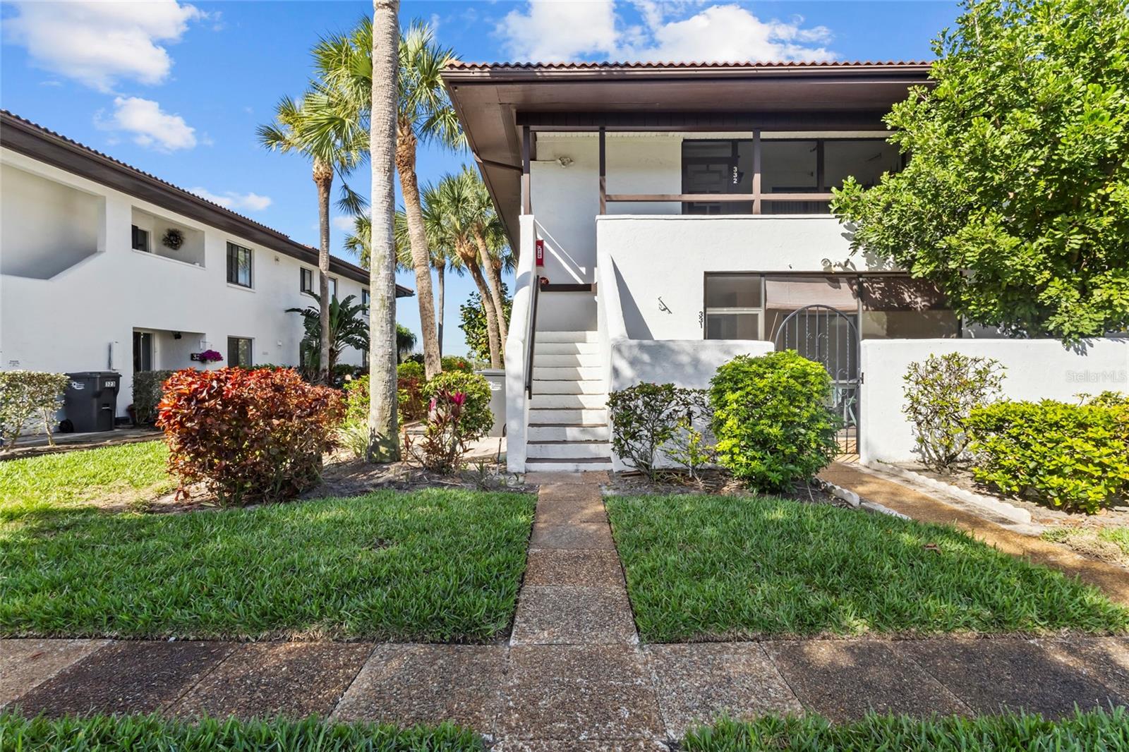 One or more photo(s) has been virtually staged. Enjoy the relaxed golf course lifestyle in this 2-bedroom, 2-bath second-floor condo located in the desirable Valencia Gardens community overlooking IMG Academy Golf Club. Perfectly positioned to capture peaceful water views along with views of the driving range and the first hole, this home offers a scenic setting that golf lovers will appreciate every day.
Inside, the living and dining room combination creates an open, comfortable gathering space, with windows that frame the golf course views. The kitchen features a convenient pass-through to the main living area, keeping the layout open and functional for daily living or entertaining.
A Florida room adds approximately 188 square feet of additional living space, providing the perfect spot to relax, work, or enjoy the tranquil golf and water views. The condo also features new carpet throughout the main living areas and a new AC installed in December 2025, offering both comfort and peace of mind.
Both bedrooms feature ensuite bathrooms, creating privacy and flexibility for owners and guests. The primary suite includes a walk-in closet and a partial view of the golf course, while one bathroom feature tub/shower combination the other offers a shower stall. The home retains much of its original kitchen and bathroom finishes, presenting a great opportunity for buyers to update and customize to their personal style.
Additional features include a screened front porch, enclosed laundry room, and lush landscaped entrance.
Conveniently located near IMG Academy and IMG Academy Golf Club, this property is also less than 2 miles to State College of Florida and approximately 8 miles to the beautiful beaches of Anna Maria Island and Bradenton Beach.
Whether you're searching for a seasonal retreat, investment opportunity, or full-time residence, this condo offers golf course views, a desirable location, and the chance to add your own personal updates.