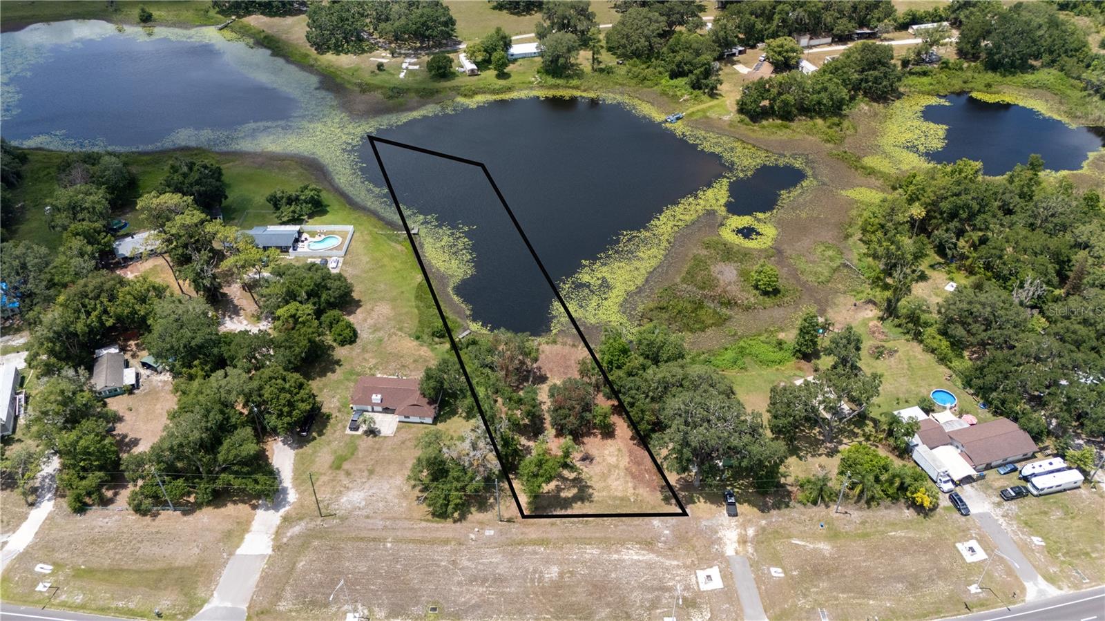 A lakefront opportunity along State Road 52 is not something you come across every day. This 1.76 acre residential homesite gives future owners a rare lakeside setting with plenty of room to design a stunning home focused on the view. A portion of the property extends into Pierce Lake, creating a beautiful backdrop for outdoor living, wide water views, and a custom home built with the scenery in mind. A few scattered trees add natural character without overwhelming the land, leaving a flexible blank slate for the next owner’s vision. Picture a backyard oasis facing the water, large windows framing the lake, and the ability to build your dream home exactly the way you want it. With a convenient location along State Road 52, this property keeps you close to nearby communities, major roadways, shopping, dining, and daily necessities. Whether you are ready to build now or secure a lakefront parcel for the future, this 1.76 acre property along Pierce Lake is a beautiful place to begin. Reach out today for more information!