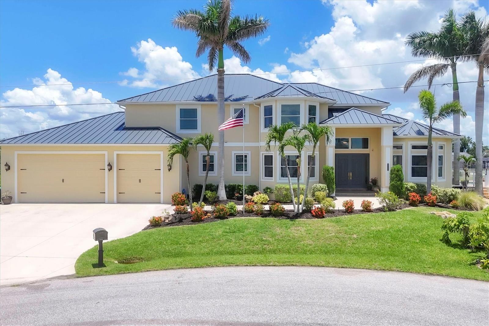 Introducing “River Breeze at Paradise Point” – the whimsical name of this breathtaking property, affectionately bestowed by the current owners.  This stunning waterfront estate, stretching across 0.39 acres, is perched along the Myakka River with quick access to Charlotte Harbor and a 30-minute boat ride to the Gulf. It’s every boater’s dream to the best fishing in Southwest Florida, featuring 185 feet of concrete seawall, a 167-foot captain’s walk, and a 2023 metal-roofed boathouse with a 16,000 lb remote-controlled boat lift. Enjoy dolphin, manatee, and bald eagle sightings, or cast a line for record snook, world-renown tarpon, and redfish—all from your backyard. The home offers 3,825 sq ft of living space and a spacious, well-organized 1,327 sq ft 4+ car garage with 10.5-foot ceilings. Inside, the soaring 20-foot foyer with a sweeping staircase leads into a bright music room with 12-foot bamboo tray ceiling, and an entertainer’s dream kitchen featuring a massive quartz island, updated cabinetry, stainless appliances, and three built-in dishwashers. The kitchen flows seamlessly into the dining and bar areas and out to a 56-foot screened patio and extended lanai—perfect for year-round indoor-outdoor living. Step out to the heated saltwater pool, surrounded by open-air lounge space ideal for relaxing in the Florida sunshine. The primary suite is a private retreat with a sitting area, two walk-in closets, a luxurious 14x14 bathroom with a 5x7 glass shower, and direct access to a private waterfront balcony. The primary guest suite also features a private balcony and river views. Every bedroom is en suite, ensuring comfort and privacy for guests. Throughout the home, enjoy travertine and engineered wood flooring with porcelain tile in 2nd level bathrooms, detailed crown molding, and abundant storage including multiple custom closets. Additional recent upgrades include a new standing seam metal roof (house and boathouse), two new A/C units with whole-home UV filtration, spray foam insulation, PECS plumbing system, impact-resistant windows and doors throughout, and fresh interior/exterior paint. The pool features a new heat pump, chlorine generator, and variable-speed pump, while rebuilt decks and upgraded kitchen and baths further elevate the home's quality and style. Tucked away in Gulf Cove, a hidden gem community known for its quiet streets, friendly neighbors, and walkable, bike-friendly atmosphere, this exceptional home offers luxury, comfort, and breathtaking water views—delivering unmatched waterfront living in a peaceful coastal setting.