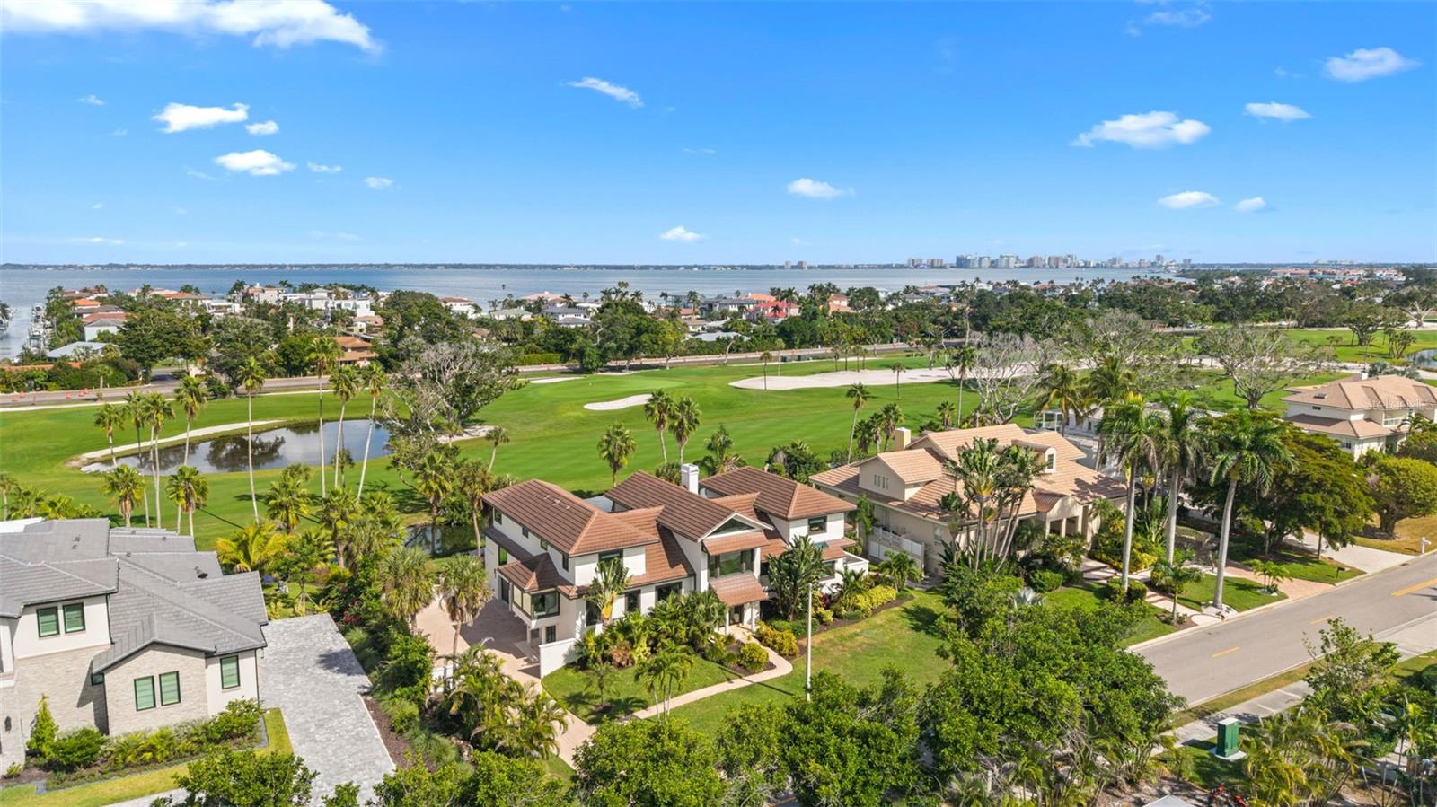 Distinctive Longboat Key Estate with Golf Course Views & Effortless Beach Access.
One of just 31 private estates behind the guarded gates of the Longboat Key Club, this exceptional residence offers over 5,100 square feet of thoughtfully designed living space with a striking architectural presence rarely found in the area.
The open layout includes five en-suite bedrooms, a dedicated office, and a versatile bonus room ideal as a second office, media room, or play space. At the heart of the home, a dramatic two-story living room with vaulted ceilings sets the tone for both grand entertaining and everyday comfort. A formal staircase greets guests near the entry, while a spiral stairwell connects the garage and mudroom to the kitchen and upper level. A three-stop elevator ensures easy access to all floors.
The magazine-worthy sitting room is framed by oversized windows that invite natural light and lush views, creating the perfect space to start the day with coffee or unwind with a book. The adjacent kitchen boasts dual islands and high-end Kitchen Aid appliances, and the formal dining room accommodates larger gatherings with ease. 
Outdoors, the heated infinity-edge pool offers a front-row seat to the fairways of the Longboat Key Club golf course, providing a tranquil backdrop of lush greens and daily activity. The dedicated pool bathroom enhances the convenience, while a covered outdoor dining area and summer kitchen with grill invite year-round al fresco living.
This home has been thoughtfully updated with a 5-year-old tile roof and ES hurricane impact windows and doors, ensuring peace of mind and long-term investment protection.  Generous closet and storage spaces throughout, include large walk-ins and a “Florida Basement” adjacent to the three-car garage.
Set just across the street from Regent Court, one of Longboat Key’s most exclusive Gulf-front streets and the site of the most expensive residential sale in the Sarasota region (over $30 million), this estate offers the rare opportunity to live among the highest echelon of Gulf Coast properties.
The south end of Longboat Key offers unmatched convenience, placing you just minutes from fine dining, shopping, and cultural attractions. Membership to the Longboat Key Club is optional but available, unlocking 500+ acres of luxury amenities including 45 holes of championship golf, tennis and pickleball courts, five restaurants, a spa, private beach club, marina, and fitness center.
And with public beach access just three homesites away, your toes can be in the sand within 3–4 minutes of leaving your front door.
