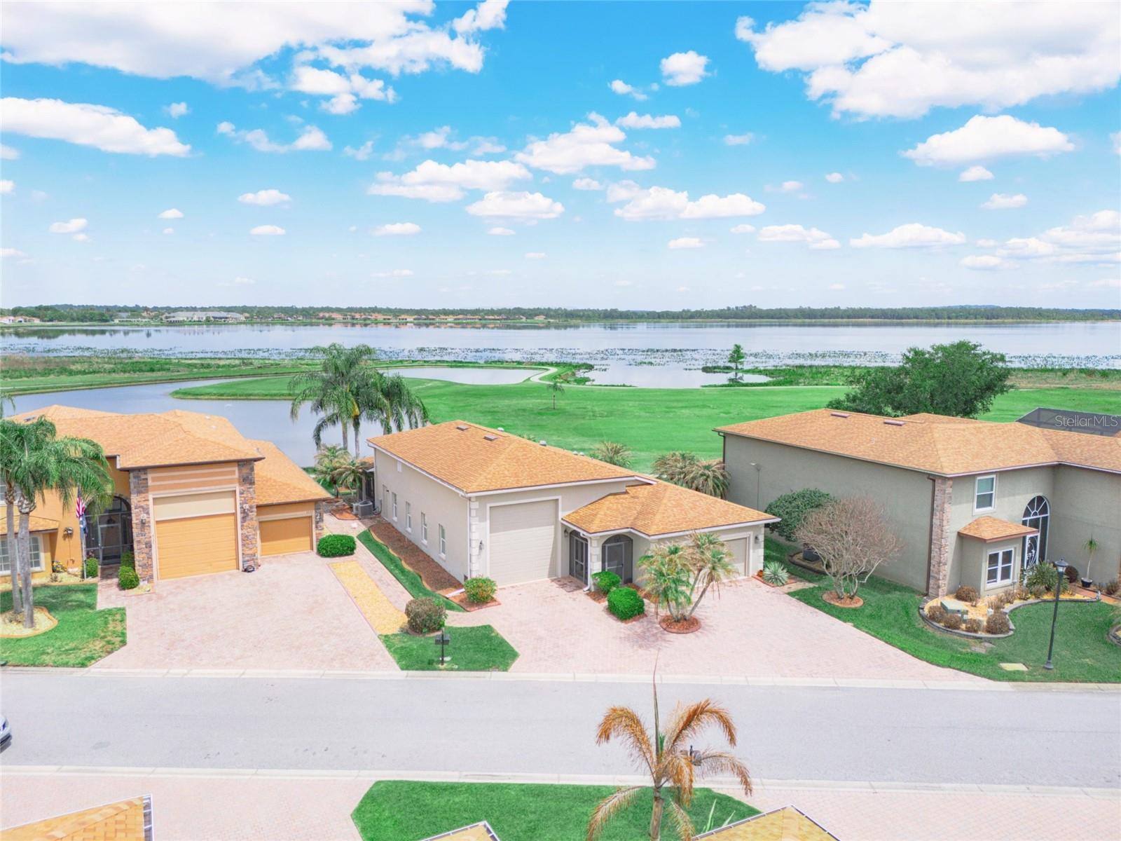 IDEAL LOCATION! AMAZING VIEW!!!! 4129 Limerick Drive Lake Wales, Florida is located on the 1st hole of Lake Ashton's East Golf Course. Bring your toothbrush-- fully furnished RV home. The location of this DeSoto RV home is desirable and offers a spectacular view of the morning sunrise over Lake Ashton. You'll enjoy the unobstructed golf and water views from one of the best lots in Lake Ashton. This 3 Bedroom / 2 Bath RV home offers a double car garage (20x21) and an RV garage (52 Ft) with hook ups. The exterior of this home is enhanced by concrete decorative edging and a paver walking path leads to the back on the home.  Enter thru the screened front entry into this RV home in Lake Ashton. The screened front lanai, leaded glass front door, side lights and storm door provide a warm welcome.  The double car garage and RV garage are both accessible from the foyer of this home. The air conditioned RV garage with epoxy coating is 52 ft. long, offers a wash sink, ventilation fan and the washer/dryer are located in this garage, too.  The 2 car garage has an automatic screen and provides privacy and ventilation into the space. The kitchen has been updated and is located just beyond the foyer of this home. Offering an Island with pull out drawers, step up breakfast bar with pendant lighting, 42" soft close cabinets with under cabinet lighting, Quartz counter tops and Stainless Steel appliances, the kitchen is a popular gathering spot. There are pull outs in select cabinets. The large combination living and dining room can easily accommodate your entertaining needs. The crown molding, tile plank flooring, custom ceiling fans and solar tubes add class to this RV home in Lake Ashton.  The dinette and adjacent family rooms are perfect locations for enjoying the fantastic views this home offers. The family room has newer windows and sliding doors that lead to the paver pad.   The guest rooms with carpet and ceiling fans are located directly off of the kitchen. The guest bath with shower/tub combo and comfort height vanity with Quartz counter top is conveniently located for guests, too. The primary suite with a separate split A/C is located on the back of the home and provides amazing water and golf course views. The primary suite has a large walk in Closet, and separate bath with a comfort height  vanity with Quartz counter top, walk in shower with glass door enclosure, linen closet, elongated toilet and upgraded lighting. The enclosed lanai with tile flooring and Acrylic windows is located on the north side of the home. It has a separate split A/C system allowing you to enjoy the room year round. Schedule an appointment to tour this RV home in Lake Ashton. Lake Ashton is a gated and guarded Florida Retirement community with resort style amenities (2 Clubhouses with Movie Theater, Restaurant, Outdoor/Indoor Pools, Fitness Centers and More! Residents enjoy activities like Karaoke, Trivia, Dances, Entertainment Series, Holiday Events and so much more. You can stay busy living the Florida Retirement Dream every single day. For those that love the game of golf, there are 2 18-Hole Golf Courses, a Pro Shop, Driving Range, Putting Green and the Eagles Nest (Hole 19). Don't wait to tour this home; tour it today!