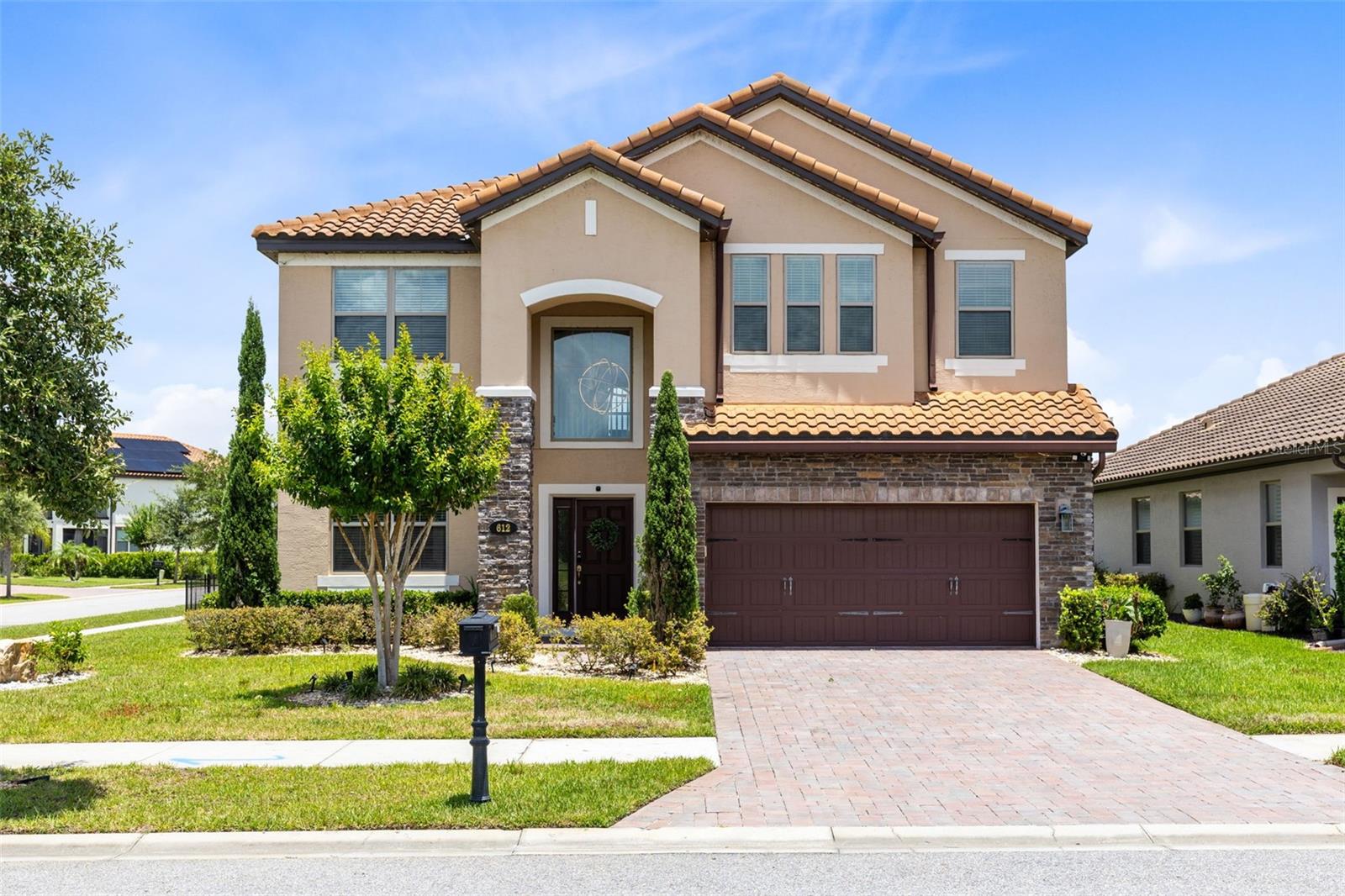 Luxury and functionality at an Unbelievable Value! Do not miss this home at 612 Via Isabelle Drive in the highly sought-after gated community of Riviera Bella in DeBary, Florida, where luxury, comfort, energy efficiency, and resort-style amenities come together in one exceptional home. Built in 2019 and offering thoughtfully designed living space, this impressive 5-bedroom, 3-bathroom residence is perfectly positioned with no front neighbors and on a large fenced corner lot, with plenty of room to create your dream backyard oasis. 
Architectural details abound with tile flooring on the main floor, crown molding, arched doorways, abundant natural light, and an open-concept layout. The front room offers a gathering-space dining area that flows seamlessly into the expansive heart of the home. The kitchen features a large island breakfast bar, granite countertops, stainless steel appliances, gas range, double ovens, tile backsplash, dry bar with wine fridge, a huge custom walk-in pantry with built-in shelving, abundant cabinetry, and generous prep space. The first floor also includes a private bedroom and full bath, creating an ideal setup for visitors, multigenerational living, or a home office. Multiple access points lead to the covered lanai and large backyard, offering the perfect indoor-outdoor flow for entertaining, relaxing evenings, or future outdoor enhancements. Luxury vinyl flooring flows up the stairs and extends throughout the second level, where you’ll find four additional bedrooms and an expansive bonus room loft. The owner’s suite serves as a true retreat, featuring double-door entry, tray ceiling detail, a private sitting area, large walk-in closet, and a spa-inspired ensuite bath complete with dual vanities, a garden soaking tub, and walk-in glass shower. Additional highlights include a spacious tandem 3-car garage with durable pebble epoxy flooring, along with a spacious laundry room with gas dryer hookup, gas water heater, two HVAC serving upstairs and downstairs, under-stair storage, smart home wiring, updated lighting fixtures, ceiling fans, Low-E double-pane windows and sliding glass doors, and energy-efficient construction. Built to M/I Homes Whole Home Standards and Energy Star 3.1 Certified, the property includes features such as Core Fill insulation in block walls, R-38 ceiling insulation, raised heel trusses, full perimeter rebar construction including the garage, and a 3,000 PSI concrete foundation, providing long-term efficiency, durability, and peace of mind. Riviera Bella residents enjoy an exceptional lifestyle with private community access to the St. Johns River, allowing boating, kayaking, jet skiing, and water recreation just moments from home. Community amenities include a resort-style clubhouse with media room, fitness center, zero-entry pool, splash pad, playgrounds, parks, walking trails, and scenic surroundings. Conveniently located near I-4, the DeBary SunRail Station, shopping, dining, beaches, Orlando attractions, and great schools, this home offers the perfect balance of luxury living and everyday convenience. Do not wait. Schedule your showing today!