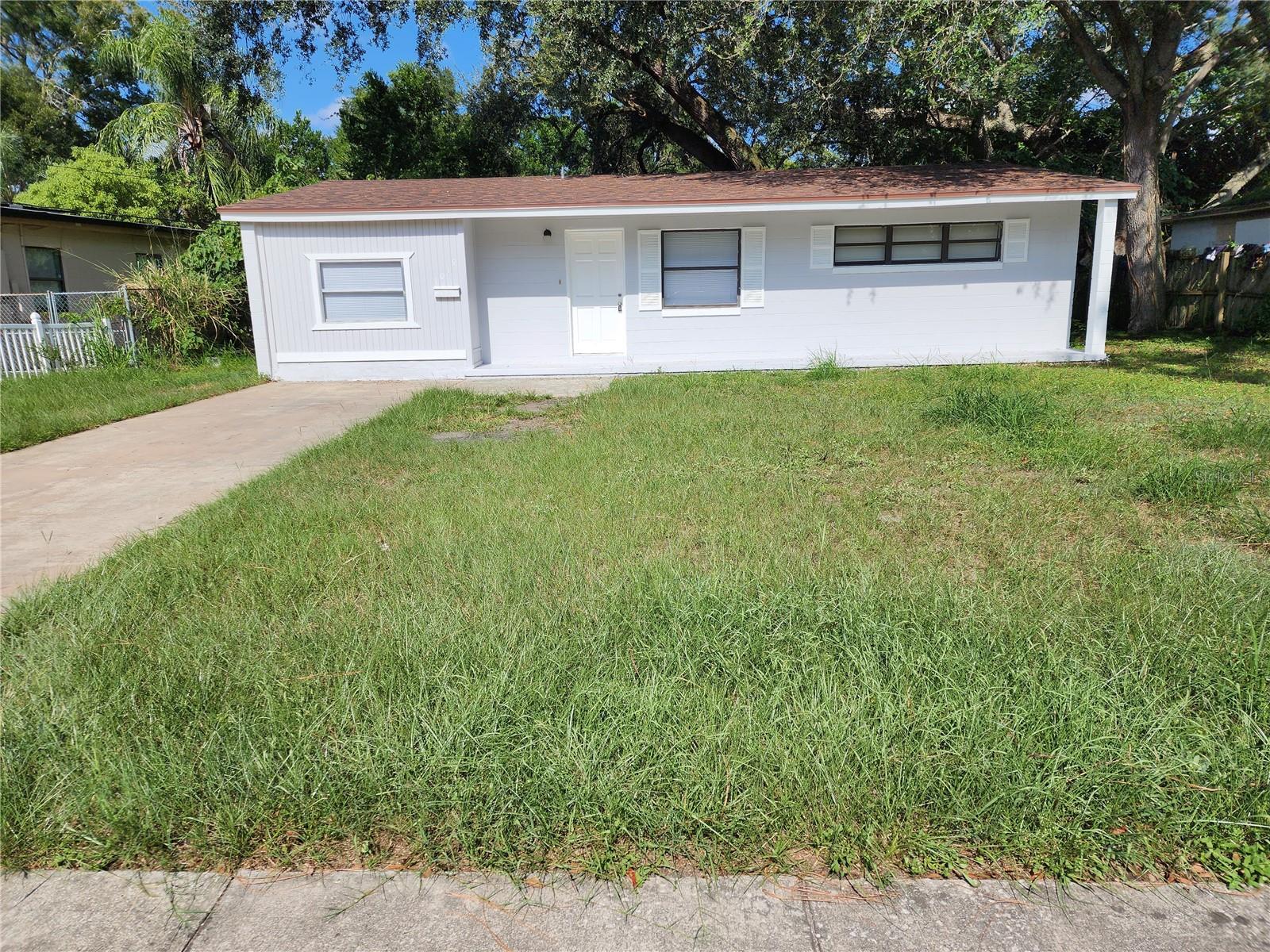 BACK ON THE MARKET now with complete electrical rewire!!! Come see this charming three bedroom, one bathroom home recently renovated inside and out in the heart of Orlando.  Get ready to beat the heat with your all new air conditioner while inside under your all new roof!  Instantly be greeted by the spacious living room when you walk in the door.  Just beyond, you’ll find the recently updated kitchen featuring new cabinets and countertops.  The stainless-steel appliances stay with the home.  The dining room is just shy of the kitchen and will make the perfect place for meals with your family.  The recently painted master bedroom features a ton of closet space.  The remaining rooms of the split floorplan have also been recently painted and will work great when accommodating your family and guests.  New paint inside and out as well as new flooring awaits you.  The bathroom has been fully remodeled.  Out back you’ll find a large back yard, featuring a concrete slab perfect for you to park you grill.   This home is close to the bus line, with major roads giving you quick and easy access to downtown, area restaurants, and shopping centers.   Call your agent now!  FHA welcome!