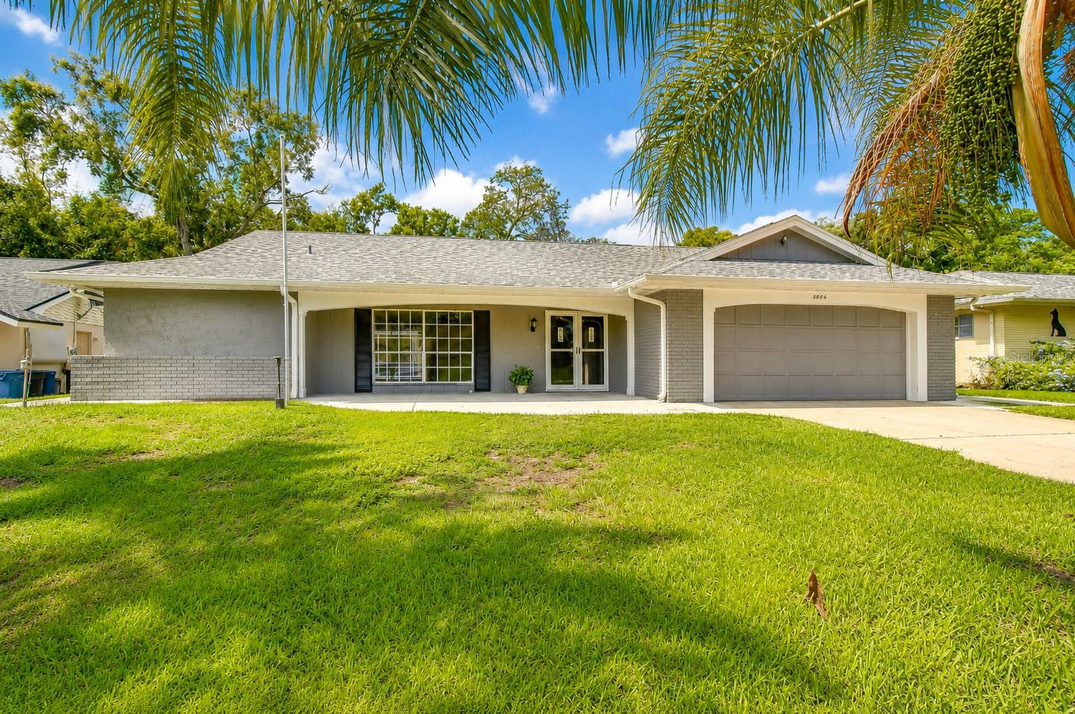 Spacious Pool Home in Beacon Woods – Move-In Ready! Tucked away on a cul-de-sac, this exceptional waterfront property offers peace, privacy, and breathtaking natural surroundings. With no rear neighbors, your backyard overlooks a tranquil freshwater canal framed by majestic magnolia, pine, and oak trees, creating the perfect setting to enjoy Florida's abundant wildlife. Located in the highly desirable Beacon Woods community with a low HOA, this beautifully maintained 2-bedroom, 2-bathroom, 2-car garage pool home is truly move-in ready. Originally designed as a three-bedroom home, one bedroom has been thoughtfully incorporated into the living area to create a more spacious and open floor plan. If desired, it can easily be converted back to a third bedroom. The split-bedroom layout provides added privacy, while the expansive living and family rooms offer plenty of space for entertaining or everyday living. Large windows and sliding glass doors fill the home with natural light and showcase the beautiful outdoor views. The spacious primary suite features direct access to the screened pool and a luxurious en-suite bath complete with a soaking tub, separate walk-in shower with a rain shower head. The second bedroom is generously sized and includes dual closets for ample storage. Step outside to your private screened-in pool and enjoy peaceful canal views in a backyard designed for relaxation and outdoor entertaining. The oversized driveway and attached two-car garage provide abundant parking and additional storage. Beacon Woods residents enjoy an impressive array of amenities, including a clubhouse, community pool, fitness center, tennis courts, basketball courts, bocce courts, and more. Conveniently located near shopping, restaurants, medical facilities, golf courses, and the beautiful Gulf Coast beaches, this home offers the perfect combination of comfort, convenience, and natural beauty. Don't miss your chance to own this one-of-a-kind waterfront retreat—schedule your private showing today!