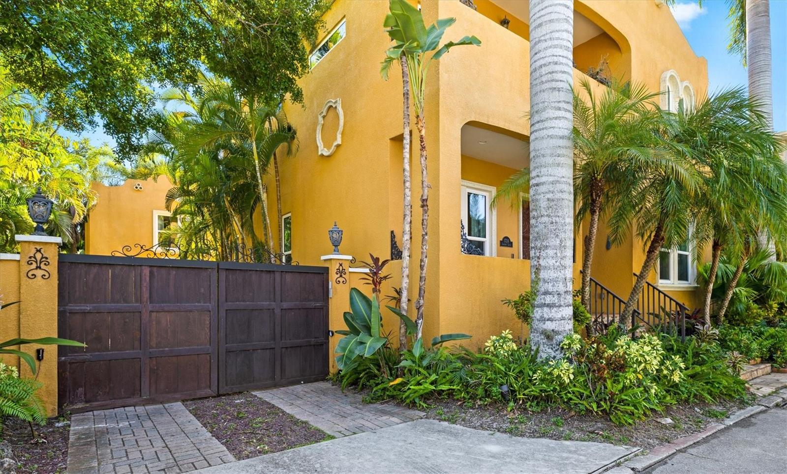 Welcome to your own private Spanish-Mediterranean-inspired sanctuary, perfectly nestled in the heart of Sarasota’s historical Laurel Park. This rare exquisitely updated 4-bedroom, 3.5-bath residence blends timeless charm with modern sophistication offering a dynamic combination of style, comfort, and versatility. This private gated home offers a separate guest or in-law suite with a full kitchen and en-suite bath ideal for extended family, visitors, or potential rental income. Step outside into a lush, resort-style backyard, where tropical landscaping frames a shimmering turquoise saltwater pool/spa and a retractable awning to enjoy your personal oasis for relaxing afternoons or elegant entertaining. Inside, the main home's fully renovated first level boasts European white oak flooring, a thoughtfully designed chef’s kitchen, and bespoke finishes throughout. Unique touches include a custom ventilated cat retreat tucked playfully beneath the staircase, blending charm and creativity. The newly crafted white oak staircase leads to the upper level, where the white oak floors continue and lime-washed plaster walls create a soft, elevated ambiance that’s both serene and stylish. All of this, just steps away from the vibrant lifestyle of downtown Sarasota; including Burns Court, Selby Gardens, and an abundance of dining, arts, and cultural attractions. There is also a kayak launch around the corner, so you're able to venture out via Hudson Bayou to the bay or to the neighborhood's "pocket park" on Laurel Street. With unmatched walkability and a one-of-a-kind design, this home offers a rare opportunity to live beautifully in one of Sarasota’s most beloved neighborhoods.