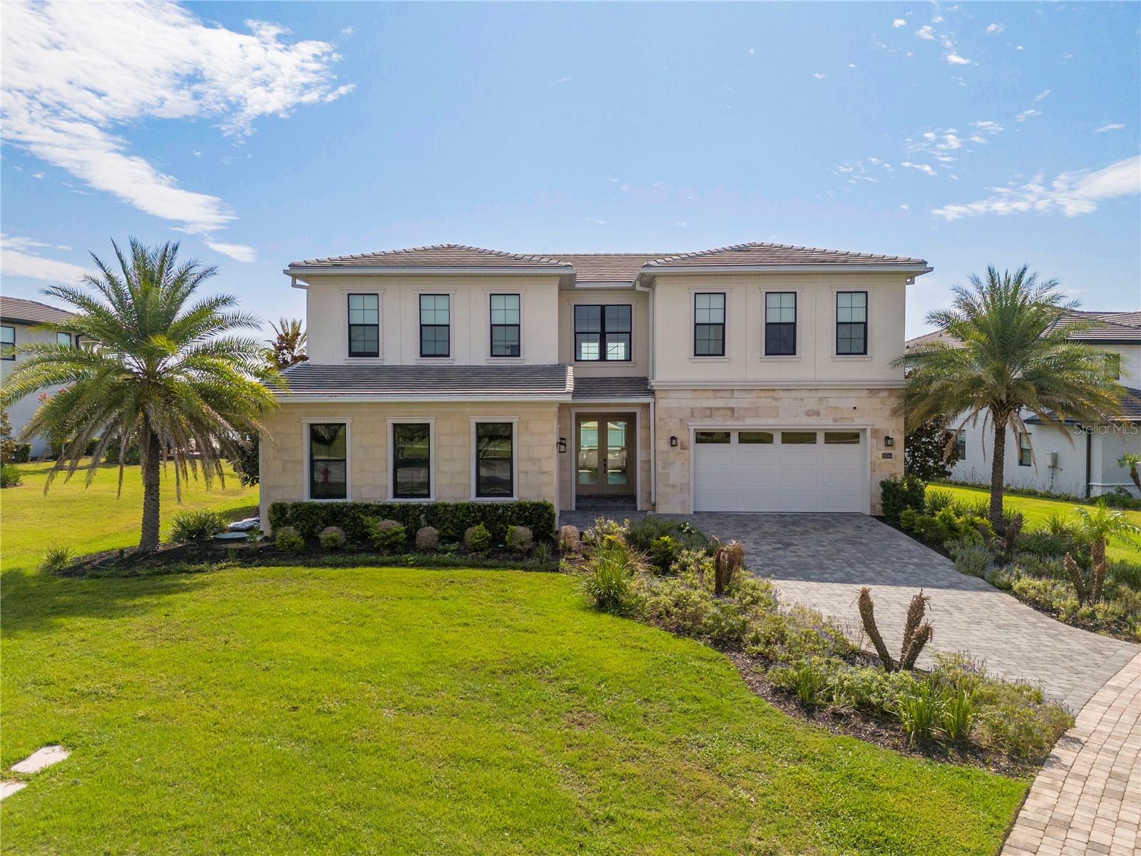Experience luxury living in this stunning Toll Brothers Barbera Transitional estate in the Bella Collina community. This exceptional residence showcases a grand two-story foyer leading to a dramatic great room with soaring 20.9-foot ceilings. Situated on a private half-acre homesite overlooking sparkling Lake Siena, the home seamlessly blends elegant indoor and outdoor living with walls of glass opening to an expansive covered lanai, a custom resort-style pool and spa featuring stunning water features, a fire pit, and breathtaking lake views.
Designed for both grand entertaining and everyday comfort, the thoughtfully crafted floor plan offers elegant formal spaces alongside inviting casual living areas. The private first-floor primary suite provides a peaceful retreat, while a first-floor guest suite with a walk-in closet offers comfort for visitors. The gourmet kitchen is a chef's dream, appointed with quartz countertops, premium JennAir appliances, Thermador wine fridge, abundant cabinetry, an oversized walk-in pantry, and a large center island that flows effortlessly into the sun-filled great room and casual dining area.
Upstairs, you'll find two spacious ensuite bedrooms, a versatile open loft ideal for a game room or lounge, and a private media room for the ultimate entertainment experience.
Residents of Bella Collina enjoy world-class amenities, including two restaurants, a full-service fitness center, Har-Tru tennis courts, a resort-style community pool, and the Sir Nick Faldo-designed 18-hole championship golf course. This is an exceptional opportunity to own a luxurious lakefront home in one of Central Florida's premier private golf communities.