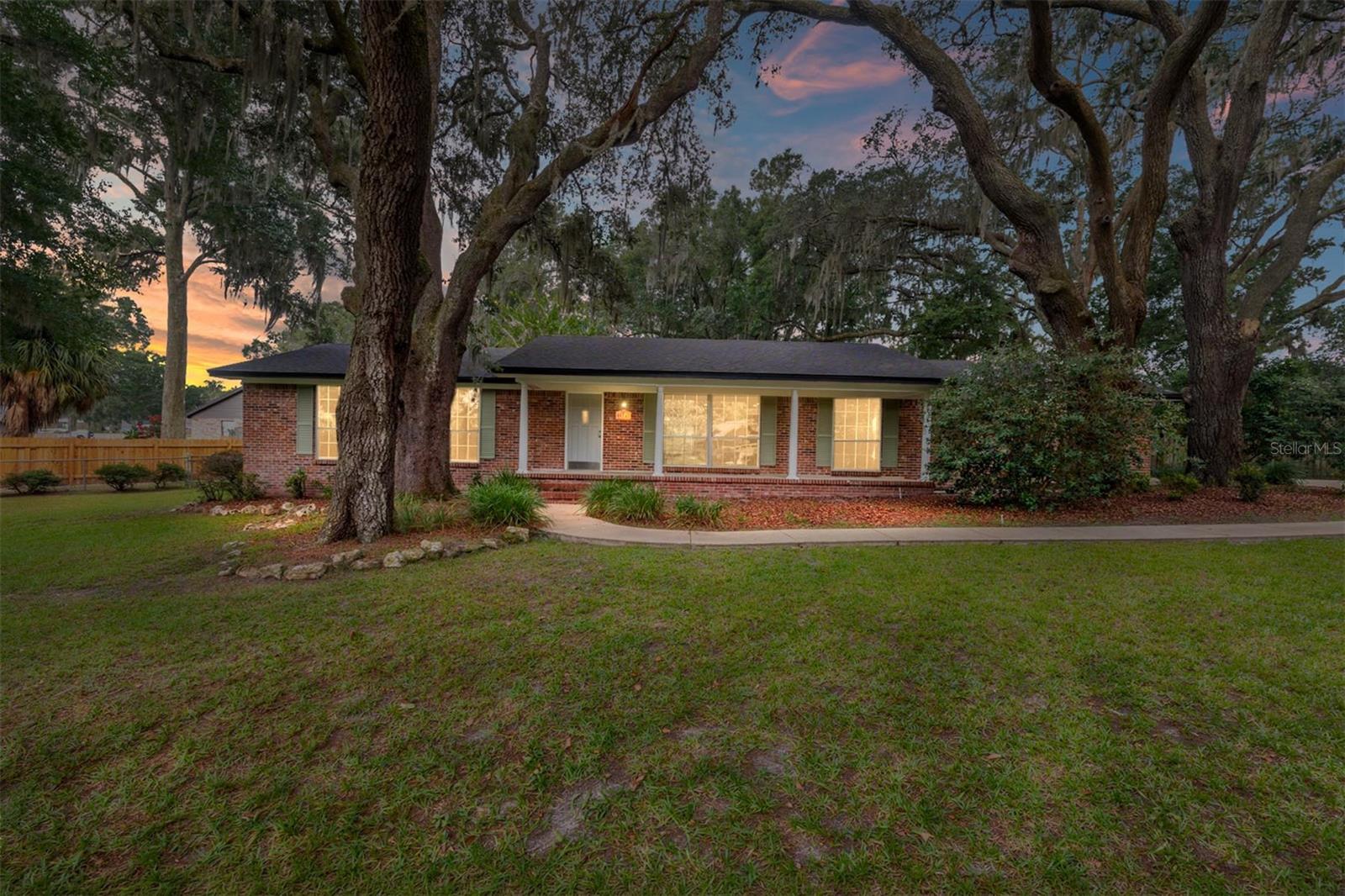 Virtually Staged. Welcome to this adorable 3-bedroom, 2-bath home nestled at the end of a quiet cul-de-sac in the highly sought-after Country Way neighborhood. The spacious open-concept living and dining area features glass sliding doors that lead to a 26' x 14' Florida room, perfect for relaxing or entertaining year-round. This Florida room offers abundant natural light, plenty of windows for fresh air, a cozy freestanding wood-burning fireplace, and new carpeting. Throughout the home, you'll find attractive laminate flooring, fresh interior and exterior paint, and numerous updates that make this property move-in ready. The kitchen has been refreshed with a new sink, faucet, and garbage disposal, while the guest bathroom has been tastefully updated. Major improvements include a new roof (2022), inside A/C unit (2020), and hot water heater (2024), providing peace of mind for years to come. Step outside to enjoy the fenced backyard, complete with a concrete slab and a 220-volt power outlet—ideal for a workshop, RV hookup, or future outdoor projects. The beautiful, mature tree canopy provides ample shade, helping keep energy costs down while creating a peaceful outdoor setting. This well-maintained home combines comfort, charm, and value in a fantastic location. Don't miss your opportunity to make it yours—schedule your showing today before it's gone!