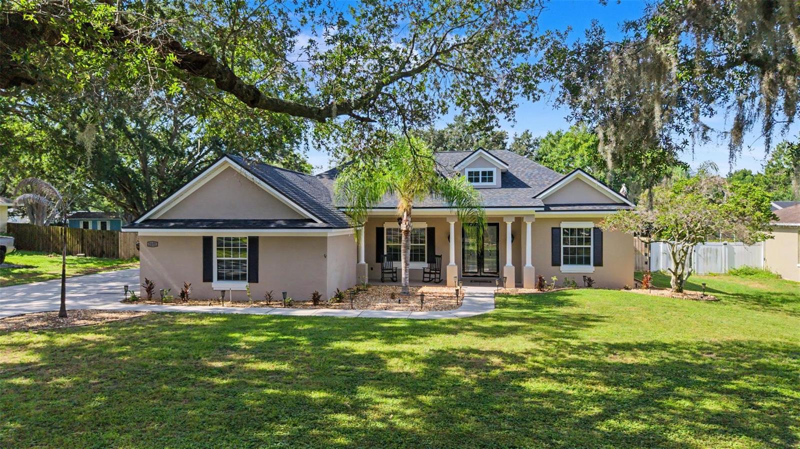 Beautifully updated home in Lakeland on a sprawling .51 acre lot!  Enjoy peace of mind with a brand new roof and fresh interior and exterior paint, all completed in 2026. From the moment you arrive, you'll be impressed by the lovingly maintained landscaping, grand entryway with elegant stone pillars and custom 8-foot French double doors. The extended driveway leads to the oversized fenced backyard complete with a large concrete pad for boat or RV storage. Step inside to discover a bright, open floor plan with soaring ceilings and luxurious finishes throughout. Crown molding, LED lighting, and updated outlets, switches, and covers elevate every space. Formal living and dining rooms welcome you at the front of the home, highlighted by a gorgeous tray ceiling and custom French doors showcasing serene pool views. The gourmet kitchen is designed to impress with pristine quartz countertops, a massive 5x7 island, stainless steel KitchenAid appliances, a JennAir stainless hood, a Kohler pro style pull down faucet, abundant cabinetry, and a spacious pantry. Overlooking the inviting family room, this space is perfect for entertaining with its striking 3D accent wall and wall sized sliding glass doors. Escape to the luxurious primary suite featuring a custom accent wall, elegant recessed LED lighting, a spacious walk-in closet with built-in cabinetry, and private French door access to the pool. The spa-inspired ensuite bathroom offers dual vanities, a walk-in shower, and a relaxing soaking tub. Your private backyard oasis awaits with a sparkling pool and spa featuring a waterfall, color-changing lights, and a screened lanai designed for year round enjoyment. Entertain with ease at the covered outdoor bar complete with a refrigerator while the built in speaker system provides music both inside and out. Avocado, pineapple, and mango plants add a tropical touch and the opportunity to enjoy fresh fruit right from your own backyard.Additional highlights include low-voltage landscape lighting on timers, a Vivint security system, a storage shed, and an oversized three-car garage with extensive shelving and attic storage. Conveniently located near shopping, dining, and major roadways. Don't miss your opportunity to make it yours!