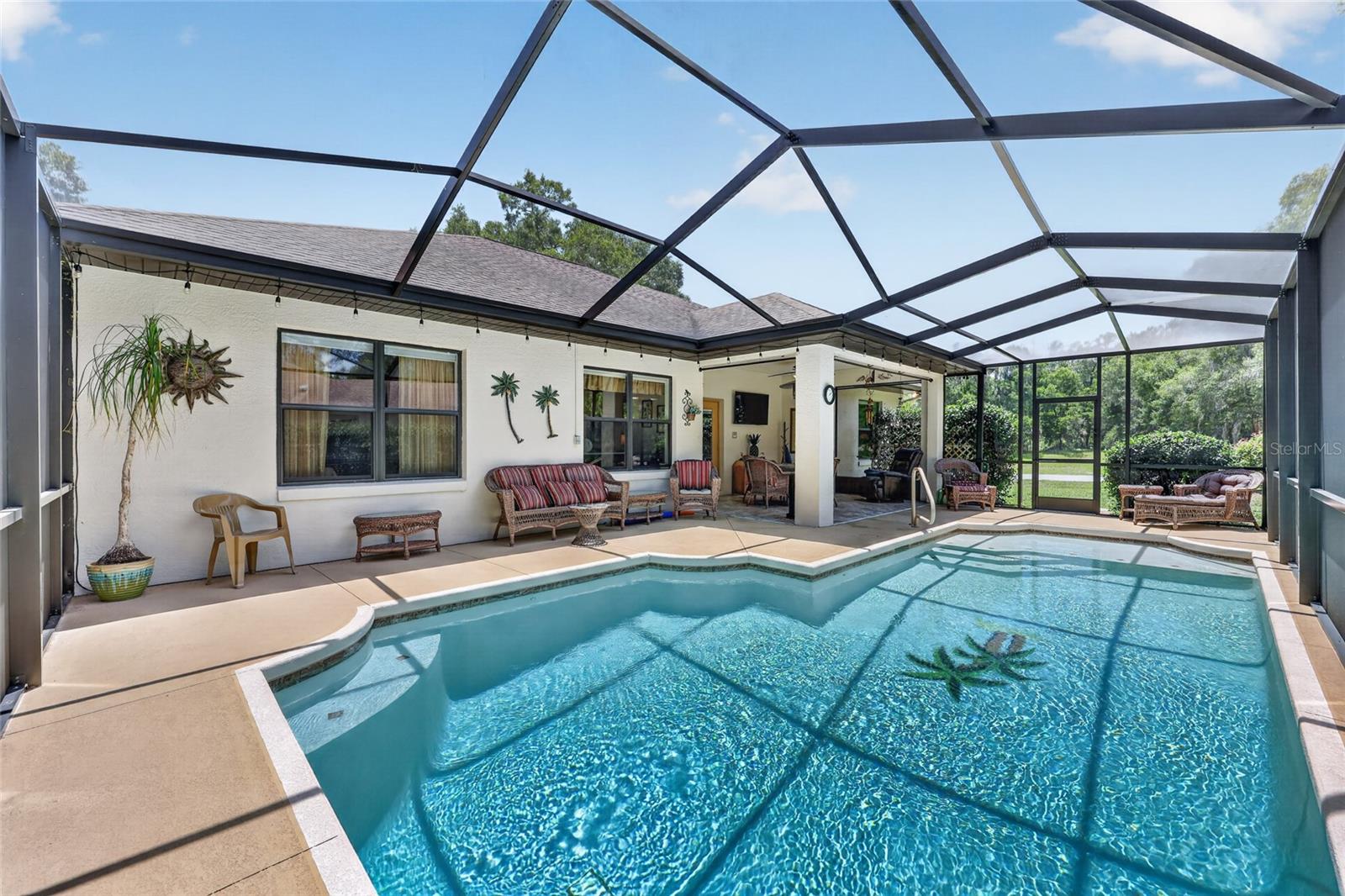 Some homes you tour. This one, you fall for. Tucked inside the charming Rainbow Springs Country Club Estates — with coveted private access to the crystal-clear Rainbow River — this beautifully updated pool home is a love letter to easy Florida living. From the moment you arrive, the landscaping, brick paver curb appeal (freshly sealed in 2025), and a crisp, newly painted exterior (also 2025) set the tone: this home has been cared for, and it shows.  Step inside, and it's suddenly five o'clock somewhere — poolside. There's no guessing where you're headed: your eye travels in one uninterrupted line straight through the heart of the home to the sparkling pool beyond, as if the house itself is nudging you toward it. It's the kind of sightline that makes a home feel like it was designed around a single, delightful idea — come on in, kick off your shoes, and keep going toward the water. The open, airy floor plan lets natural light and easy conversation flow from room to room, with each space feeling connected rather than closed off — a home that breathes and practically hands you a cold drink on the way to the pool.  The kitchen is the kind you'll actually want to gather in, thoughtfully updated with an eat-in bar for casual mornings and easy entertaining, plus a charming breakfast nook framed by windows overlooking the pool area — pour your coffee and watch the Florida sunrise before the day even asks anything of you. Elevating the interior space, Pergo flooring flows seamlessly through most of the home. The bedrooms are generously sized retreats, offering room to stretch out, unwind, and make the space entirely your own.  Out back, the heated saltwater pool invites year-round swims, sunlit lounging, and evenings that stretch a little longer than planned — because once you're poolside, "just five more minutes" always turns into a whole afternoon.  Furnishings are negotiable, so ask about the turn-key options, so all you have to do is unpack your bags and start living the Florida dream without delay.  Relax and enjoy more now - not later.  And as a bonus for peace of mind, the seller is offering a credit at closing toward roof replacement, so you can move forward with total confidence.  As a resident of Rainbow Springs Country Club Estates, you'll enjoy exclusive access to the community's private riverfront park — complete with two picnic pavilions, a kayak and paddle board launch, and a small sandy river beach perfect for a swim. Paddle just five minutes upstream to the pristine headwaters of Rainbow Springs State Park, or drift about an hour downriver to KP Hole — one of the area's most popular public parks. With a boat launch and paddle board/tube rentals, you are ready for further exploration and a full day on the water. Whether you're an early-morning paddler or a lazy-Sunday floater, the river is simply yours to enjoy.  Charming, historic Dunnellon offers a small-town welcome with local flavor — think riverside restaurants, laid-back pubs, lots of antiques shopping, and a community that still waves hello. And when you're ready to explore further, you're perfectly positioned: Ocala's shopping, dining, and equestrian culture are a short drive away; Crystal River beckons with manatee encounters and Gulf-side dining; and Inverness offers its own scenic lakes, trails, and small-town restaurants worth the trip.  This is more than a house — it's an invitation to a river-town lifestyle that's hard to find and even harder to leave.