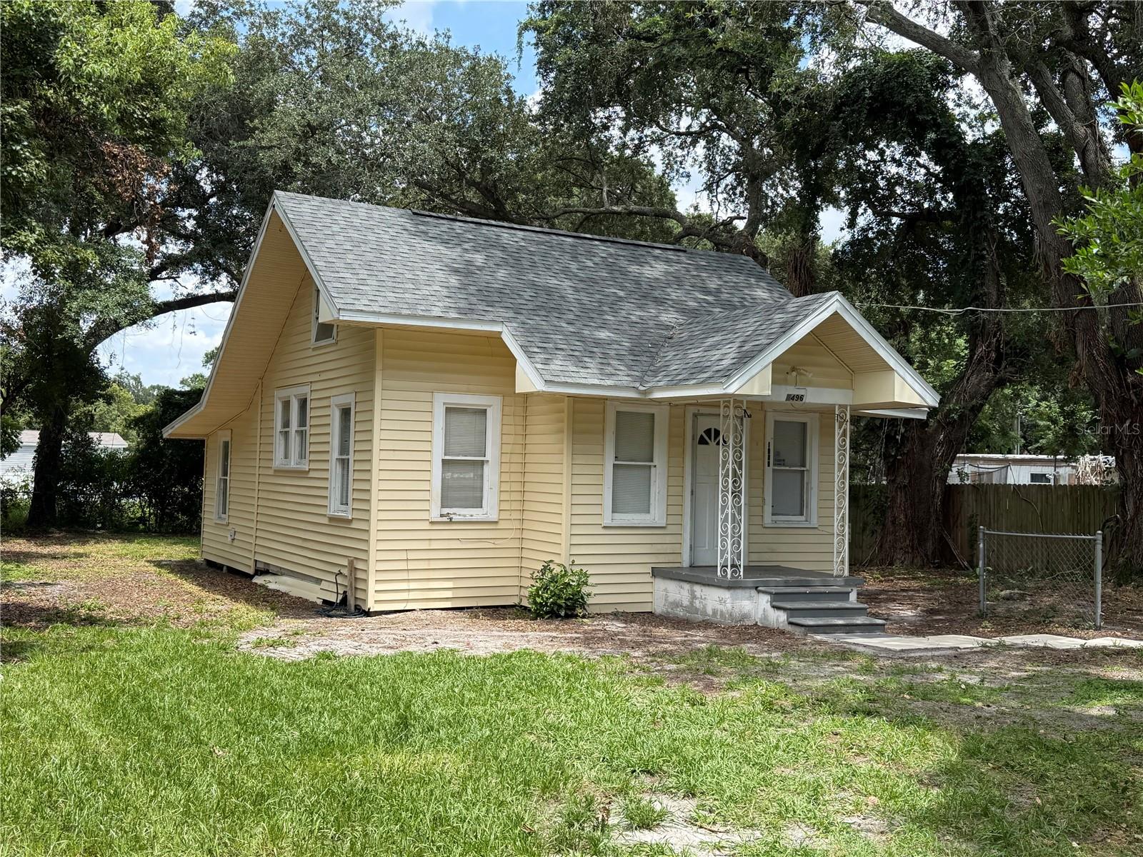 Calling all investors, flippers, landlords, and buyers looking for an affordable property with room to add value. Home was previously rented at $1150 in the current condition and could easily bring in $1500 with completed renovations. NO SIGHT UNSEEN OFFERS!!! Situated on a generously sized lot shaded by mature trees, this charming bungalow-style home is full of potential and ready for its next chapter. As you arrive, you'll appreciate the spacious lot, long driveway, and inviting covered front porch that adds to the home's timeless appeal. A major improvement has already been completed with a newer roof installed in 2026 featuring hurricane clips, along with a newer water heater, which may help reduce homeowners insurance costs. The seller is also including two brand-new window A/C units (see photos). Inside, you'll find a functional layout featuring a living area, eat-in kitchen, two bedrooms, and one bathroom. The home offers a solid foundation for renovations and personal touches, providing an excellent opportunity to create value and maximize its potential. The home will require a new kitchen , bath, flooring, and cosmetic work. One of the property's standout features is the expansive backyard, offering plenty of room for gardening, entertaining, pets, storage, or future improvements. Large lots like this are becoming increasingly difficult to find at this price point. The lot is also mostly fenced. The property is being sold as-is and will require repairs and updates. Buyers are encouraged to independently verify the condition and functionality of all appliances and systems. If you're searching for an affordable property with a large yard, key capital improvements already completed, and excellent upside potential Conveniently located just minutes from Winter Haven's Chain of Lakes, shopping, restaurants, medical facilities, parks, downtown Winter Haven, and major transportation routes, this property provides easy access to everything Central Florida has to offer.