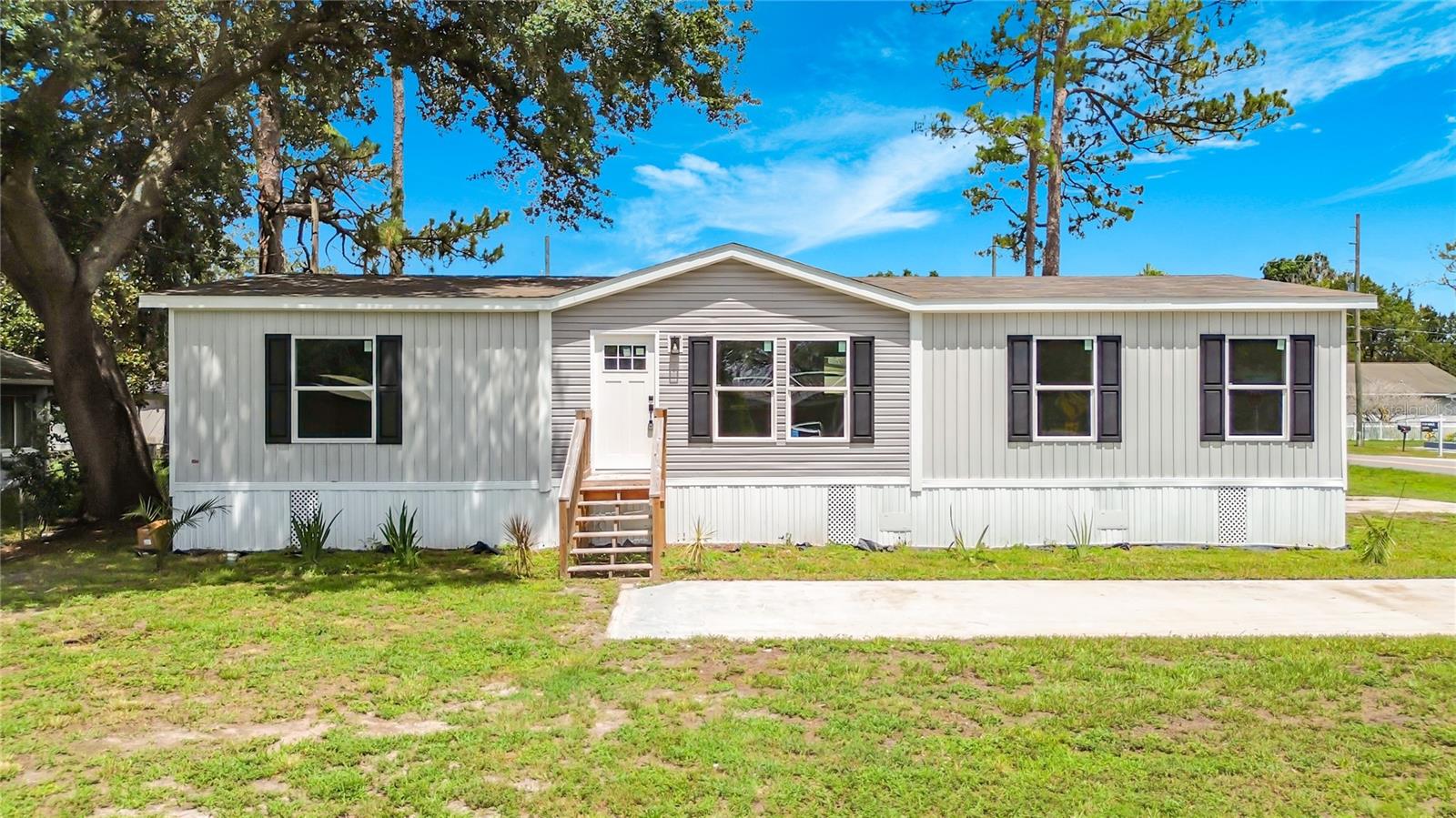 Brand new, never-lived-in 3-bedroom, 2-bath manufactured home situated on a spacious corner lot in the peaceful countryside of St. Cloud! This thoughtfully designed split-bedroom floor plan maximizes living space with minimal wasted hallway area. The private primary suite is located on one end of the home, while two guest bedrooms and a full bath are positioned on the opposite side for added privacy. The spacious living room flows seamlessly into the bright, modern kitchen and family-sized dining area, creating an open and inviting space for everyday living and entertaining.

Built to the U.S. Department of Energy's Zero Energy Ready Home manufactured housing standards, this home features insulated exterior doors, sealed ductwork, Pfister bathroom fixtures, Energy Star Frigidaire appliances, an ecobee smart thermostat, and is solar-ready for added energy efficiency.

The generous corner lot offers plenty of space for your boat, RV, work vehicles, or future outdoor projects. Located just two blocks from beautiful Lake Lizzie, part of the Alligator Chain of Lakes, this property is a dream for boating and fishing enthusiasts, with easy access to six connected lakes for endless days on the water. The area is well known for its boating lifestyle while still offering the peace and privacy of country living. Enjoy the tranquility of the countryside while remaining conveniently close to shopping, schools, Historic Downtown St. Cloud, the St. Cloud Lakefront, Lake Nona Medical City, Orlando International Airport, major highways, and approximately one hour from Florida's Atlantic beaches. Experience the perfect balance of outdoor adventure, rural charm, and modern convenience in this beautiful new home.