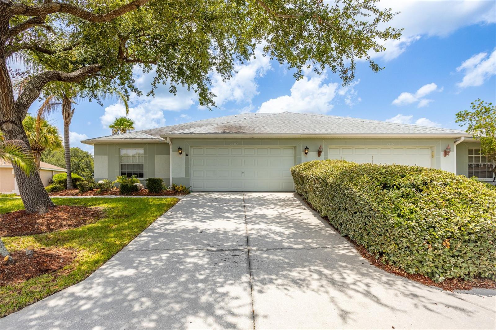 Virtually Staged. Welcome to 29312 Marker Loop, a beautifully updated 3 bedroom, 2 bathroom home offering over 1,500 square feet of comfortable living space in the sought after 55+ community of Tampa Bay Golf and Country Club. The home features new luxury vinyl plank flooring throughout, along with an updated kitchen complete with granite countertops, shaker cabinets, stainless steel appliances, and an island with tons of room for barstools and entertaining. The spacious primary suite includes a tastefully remodeled bathroom with his and hers closets and a large double vanity with quartz countertops. The spacious two car garage features new epoxy flooring.  Take advantage of all that TBGCC has to offer, with access to resort style pools, fitness and activity centers, pickleball and tennis courts, on site dining, social events and multiple golf options. Enjoy low maintenance living with an impressive selection of recreational and social amenities just outside your door!