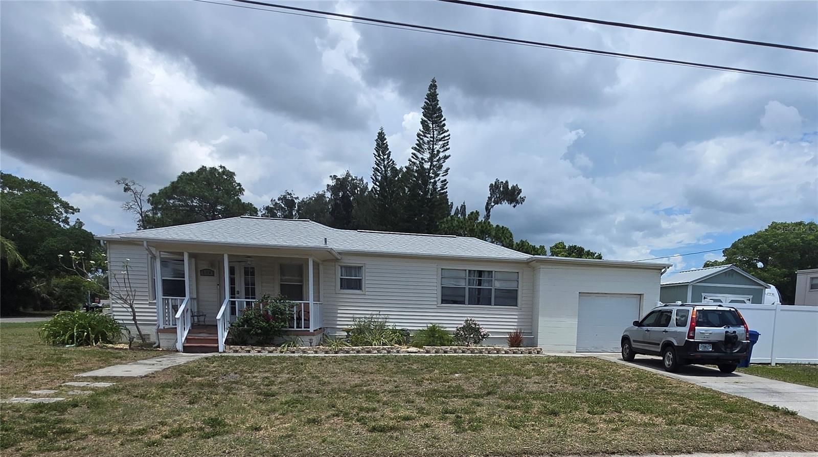 Great starter home located in the heart of St Petersburg. 3rd bedroom can be used as a dinning room or den. 3rd bedroom may be an enclose patio, buyer to verify permits.
1/2 bath located in 1 car garage area, along with washroom. Large corner lot with sectioned yard area with shed. Great for mobile home or trailer.

Property also offers front porch area, spacious living room, Jack-and-Jill bath, efficient kitchen, covered rear porch, and a large fenced backyard. 
Newer A/C (2020) and updated plumbing throughout (2019).