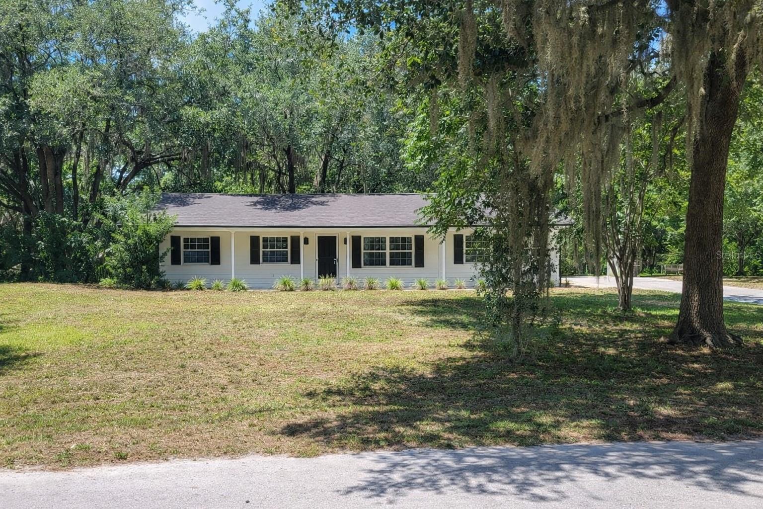 Updated 3BR/2BA Home on Private 0.62 Acres. Screened Porch. Storm Shelter. No HOA. First time ever offered for sale! This beautifully updated 3-bedroom, 2-bathroom home sits on a private and oversized 0.62-acre lot in desirable Oviedo. Built in 1986 and offering 1,287 sq ft, this move-in-ready home combines modern upgrades with space, privacy, and convenience. The interior features a brand-new kitchen and fully updated bathrooms, creating a fresh, modern feel throughout. The comfortable layout includes central air conditioning and a welcoming covered front porch surrounded by mature trees. Enjoy outdoor living from the screened porch, perfect for relaxing or entertaining while enjoying the peaceful setting. The large 2-car detached garage offers ample space for vehicles, storage, or hobbies, and includes a hurricane/storm shelter underneath, providing valuable safety and peace of mind. The expansive 0.62-acre lot offers privacy and flexibility rarely found in this area, with plenty of room for gardening, outdoor activities, or future additions. Property Features: 3 Bedrooms / 2 Bathrooms. 1,287 Sq Ft. Built 1986. Private 0.62-Acre Lot. Brand-New Kitchen. Fully Updated Bathrooms. Roof Replaced 2019. Central Air Conditioning. Screened Porch. Large 2-Car Detached Garage. Hurricane/Storm Shelter Under Garage. Covered Front Porch. Mature Trees & Private Setting. No HOA. Near Downtown Oviedo & UCF.