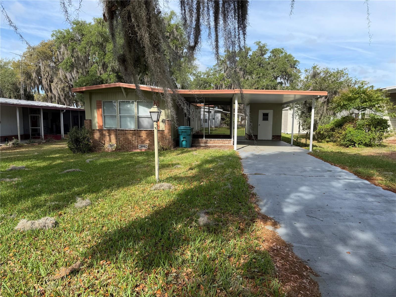 Welcome to this charming home located in a desirable 55+ community, formerly known as Wagon Wheel, now offering no deed restrictions with ownership of both home and land. Ideally situated directly across from Brownwood in The Villages, this property is perfect as a winter getaway, seasonal residence, or investment opportunity.

The home features 2 bedrooms and 1.5 bathrooms, a cozy eat-in kitchen, and a comfortable living area. Recent updates include flooring and roof repairs, and the AC system has been inspected and is in great working condition. Appliances are included, making this a move-in ready opportunity with great potential.