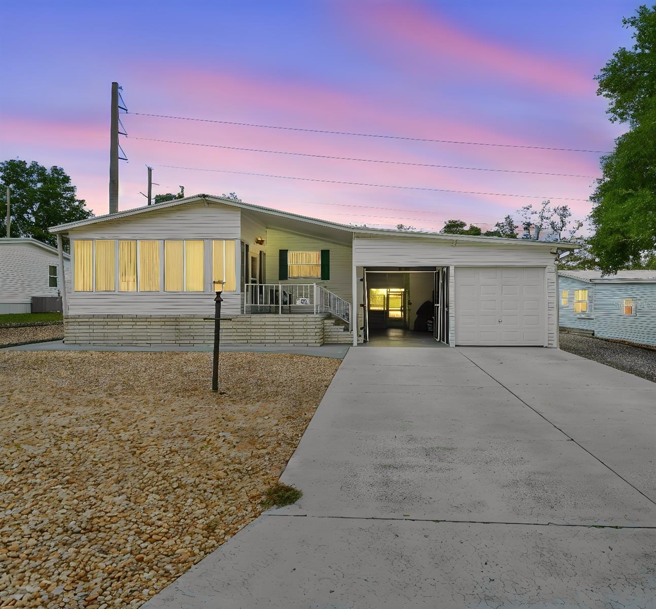 Virtually Staged. Welcome to this well-maintained 2-bedroom, 2-bath manufactured home located near shopping centers, parks and Gateway Center for the Arts. Designed for comfortable, low-maintenance living, the property features attractive dry-scaped landscaping that enhances curb appeal while reducing upkeep and water consumption. A screened two-car carport one side with an overhead bay door at the front of the home provides covered parking and a versatile space for outdoor enjoyment. At the rear, a spacious screened patio offers the perfect setting for relaxing with a morning coffee, entertaining guests, or enjoying Florida's beautiful weather year-round. Ample storage in covered inside storage/workshop and shed in rear.  THe metal roof is original to the home, HVAC 2023, Water Heater 2022, electrical panel exchanged in 2009.  Side parking ideal for RV.  

55+ community residents have the option to join the HOA and enjoy access to community recreational amenities, including a swimming pool for relaxation and social activities. Whether you're looking for a year-round residence or a seasonal getaway, this home offers an ideal blend of comfort and convenience.   (Additional photos to come.)